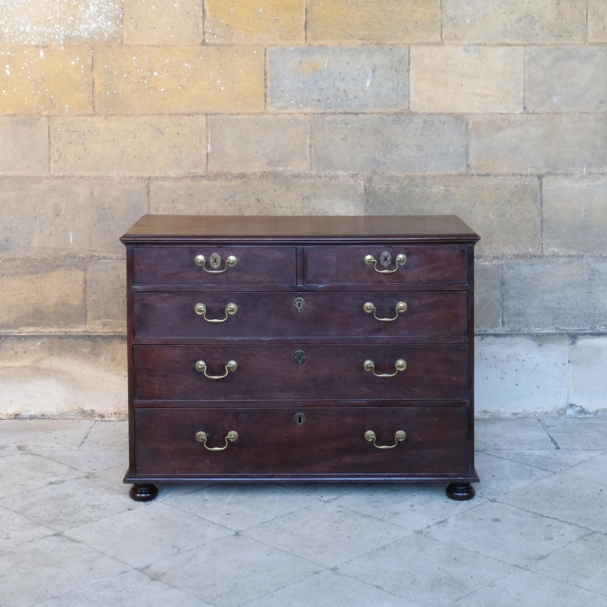 An 18th century mahogany chest of drawers, on later bun feet. Comprising two short drawers over three long, with elegant brass drop down handles and escutcheons. Masterfully restored by Anthony Beech, ACR, now in excellent condition. 