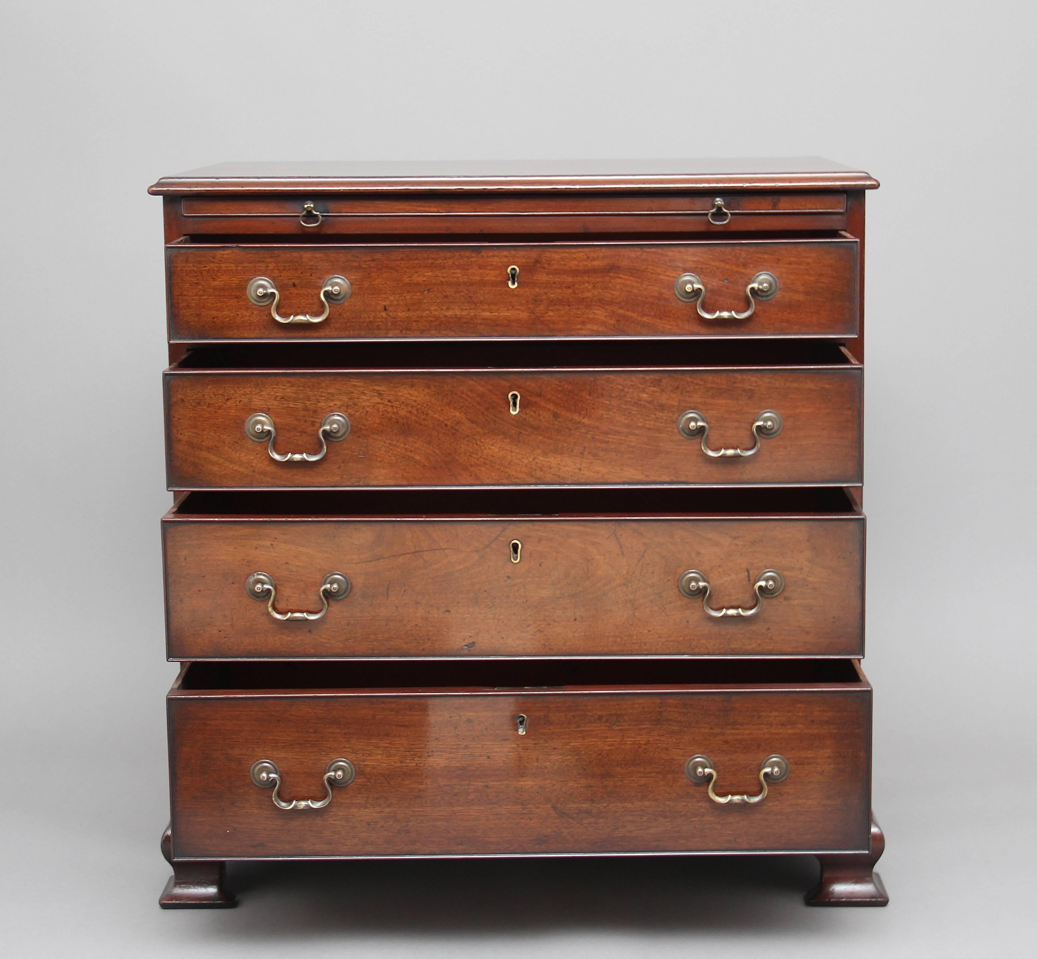 18th century mahogany Georgian flat front chest of drawers of good proportions with a brushing slide, the moulded edge top above four long graduated drawers, with original ornate brass swan neck handles, standing on ogee bracket feet, circa 1780.
 