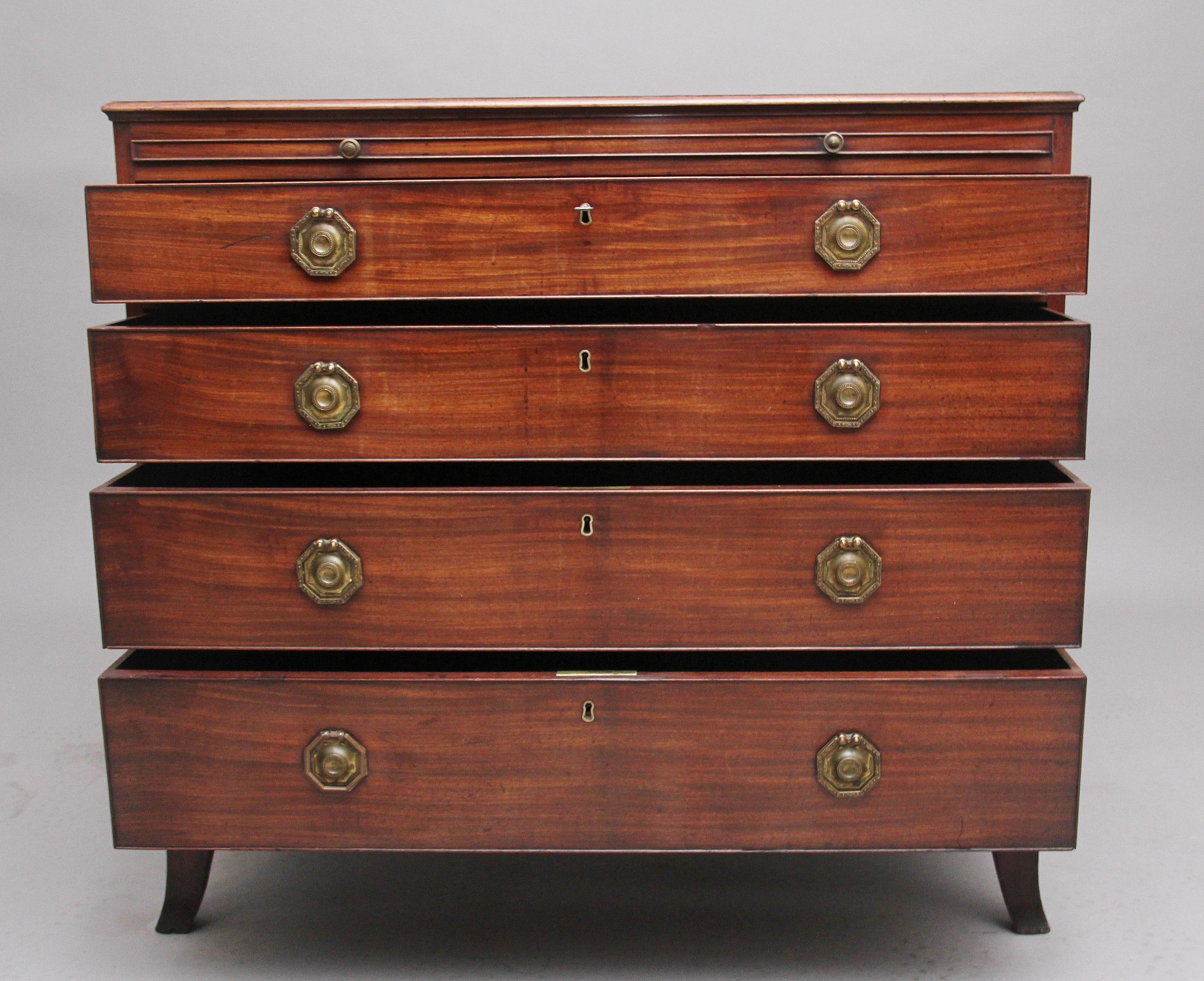 18th century mahogany chest of drawers, the moulded edge top above a brushing slide with turned brass knob handles, four graduated mahogany lined drawers below with brass engraved ring and plate handles, having a shaped apron and standing on splay