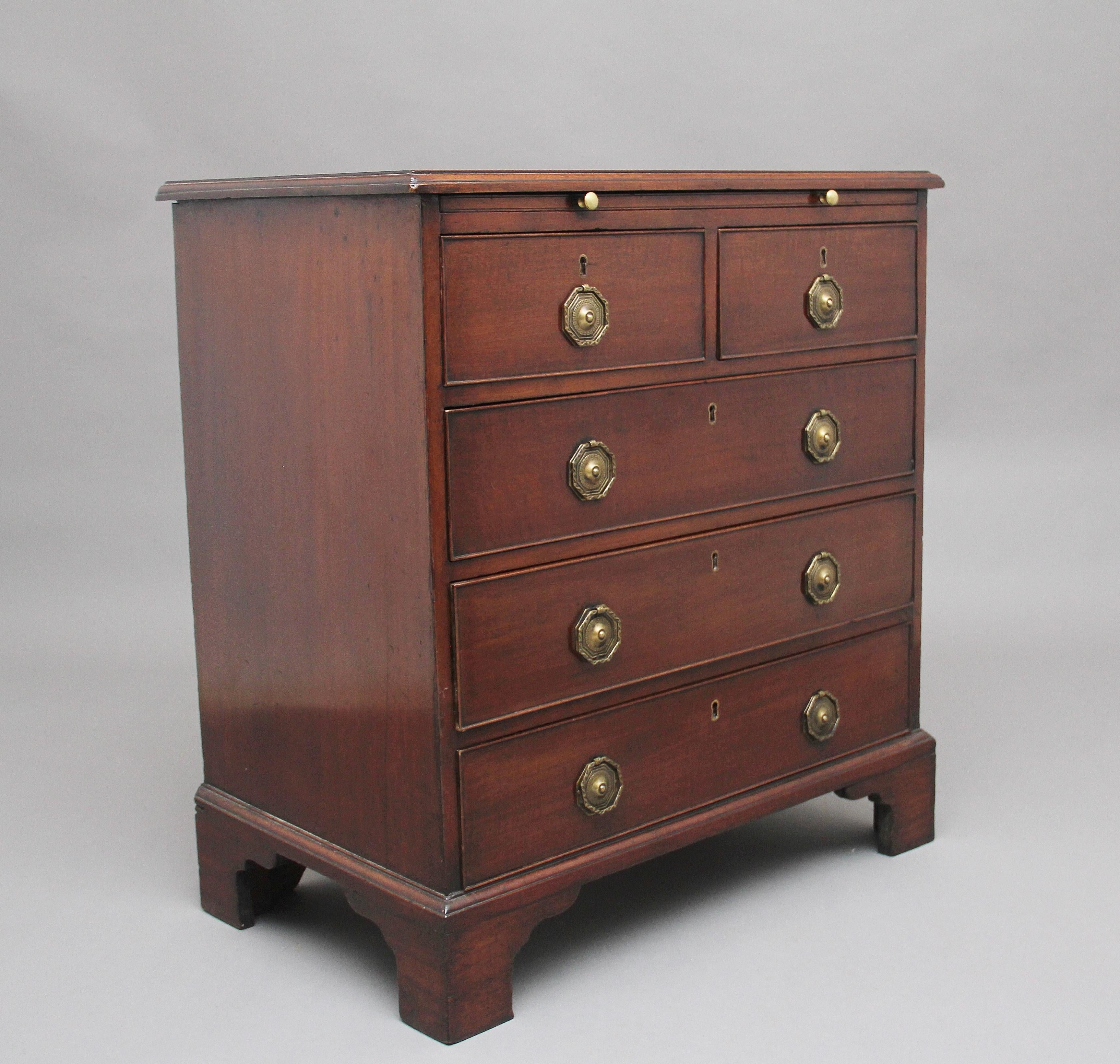 18th century mahogany chest with brushing slide, the moulded edge top above a selection of two short over three long oak lined graduated drawers with brass plate and ring handles, standing on bracket feet. Lovely warm mahogany color and in excellent