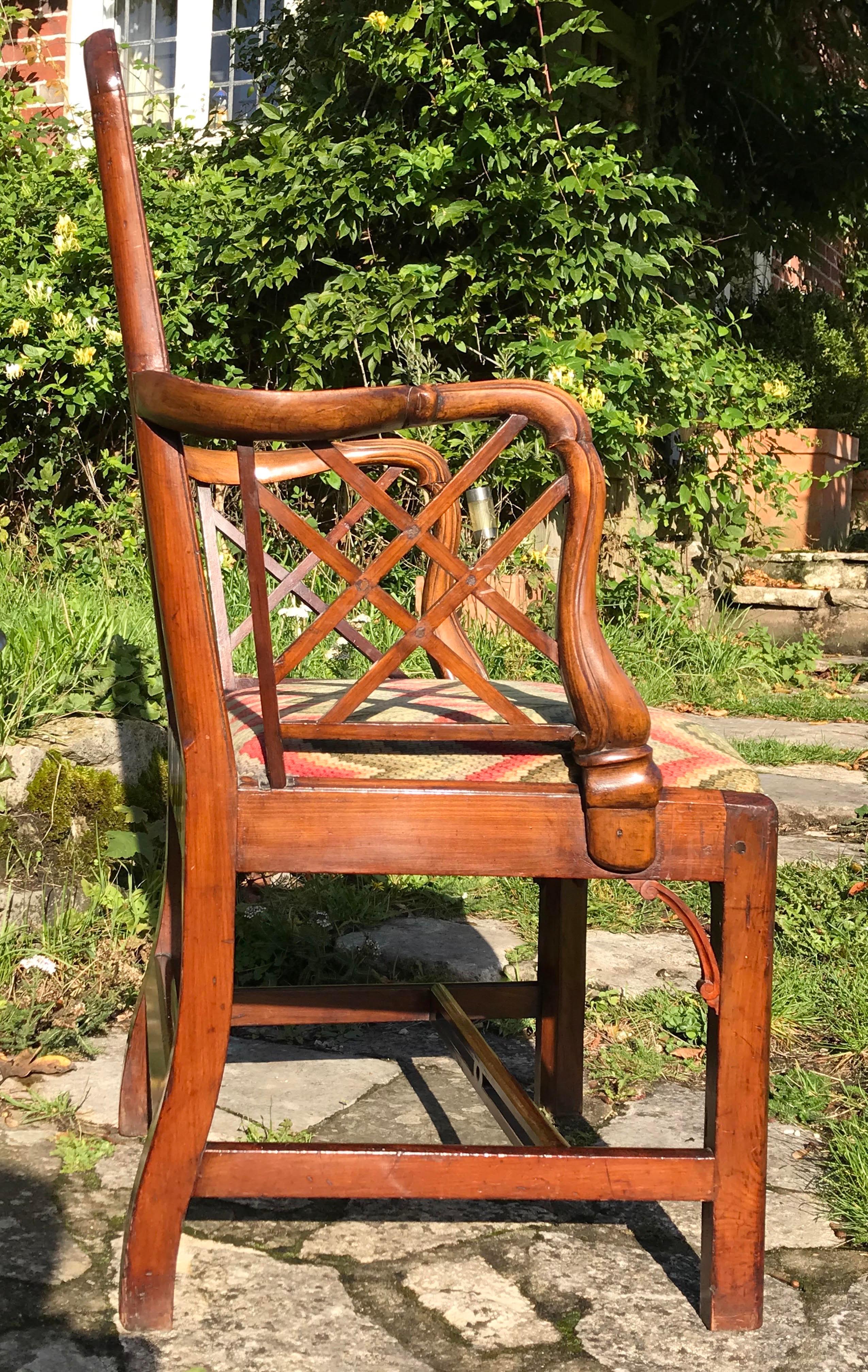 A late 18th century mahogany armchair of ''Cockpen'' design.
George III period, circa 1770.

Note the unusual treatment of the carved and moulded arm supports and pierced centre H-stretcher.
A sophisticated antique (Georgian) desk chair, or