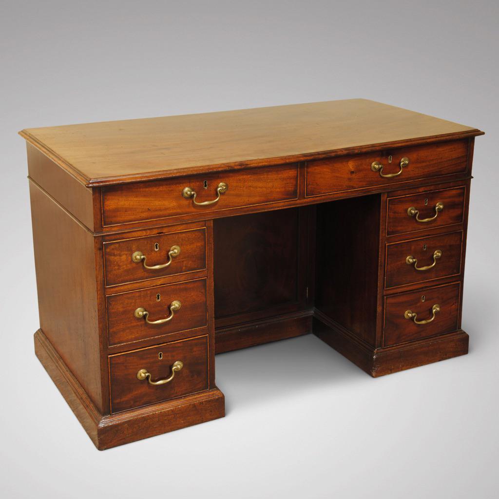 A George III period mahogany kneehole desk of good size, with the original brasses and lovely one piece top. The whole piece is of great colour and patina, circa 1780

This desk is very good to sit at with the kneehole having a narrow cupboard at