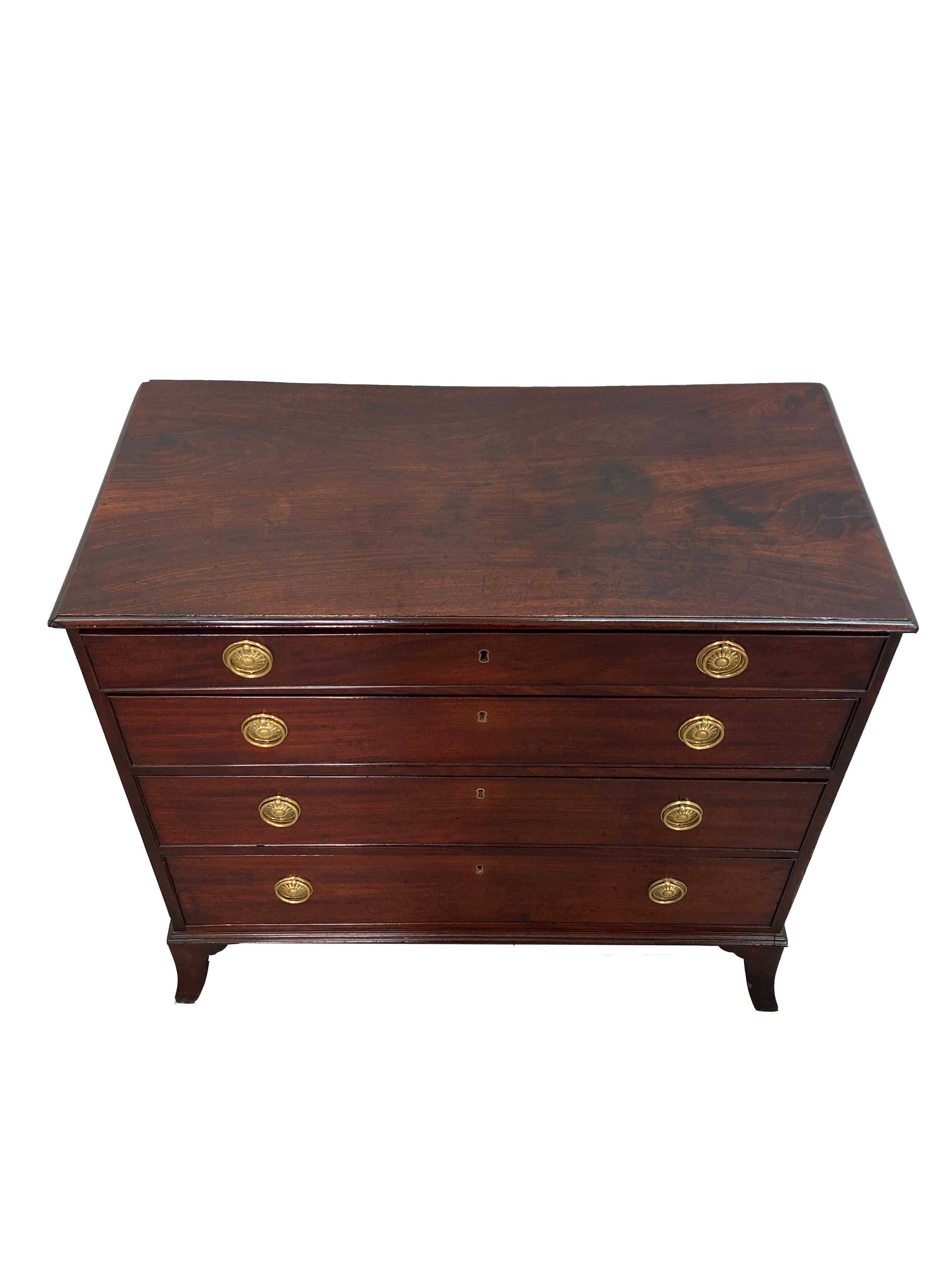 Late 18th century George III mahogany chest of drawers. A molded rectangular top over conforming case fitted with four graduated drawers resting upon bracket feet. Brass hardware. This one is in very good condition, there are two visible climatic