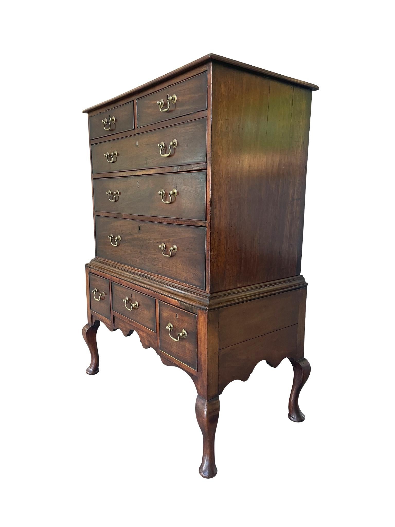 Hand-crafted in 1790, this George III highboy is comprised of mahogany with oak drawers. It has a two-part construction: an upper case piece with 2 small top drawers and 3 full-length drawers, and a lower case piece with 3 small drawers atop