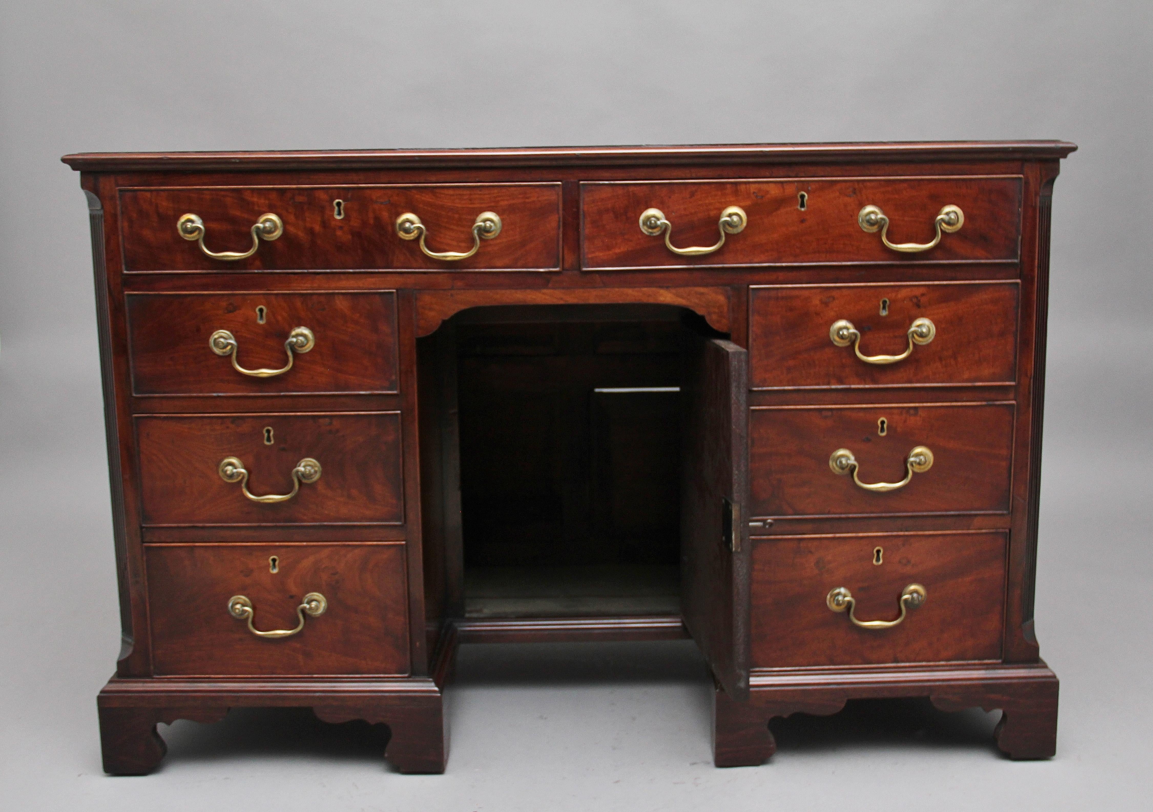 18th century mahogany kneehole desk, the rectangular moulded edge top having a brown leather writing surface decorated with blind and gold tooling, a selection of eight graduated oak lined drawers with original brass swan neck handles, lovely