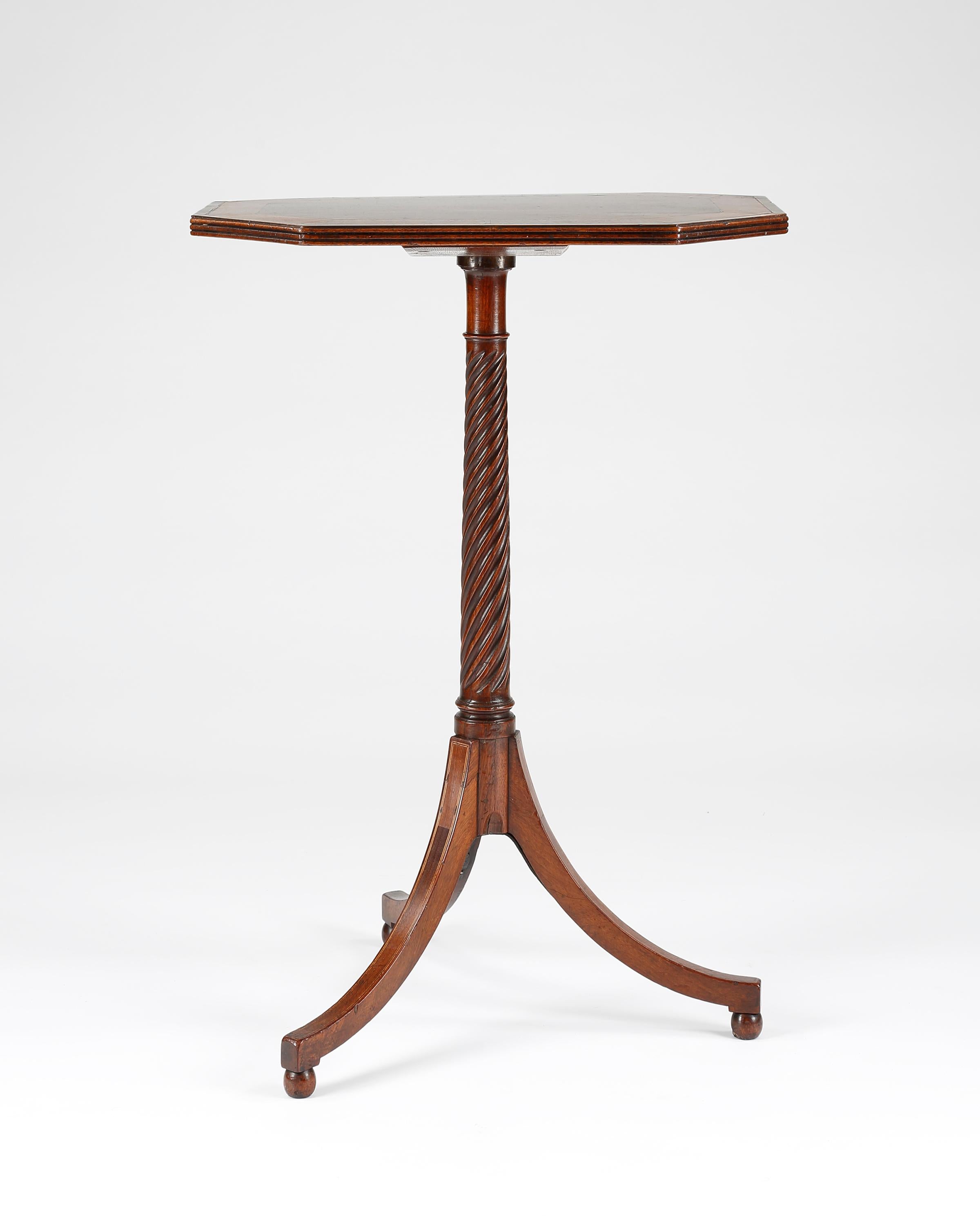 A fine elegant 18th century mahogany occasional table crossbanded in purple-hart and satinwood. The whole is strung throughout in ebony and boxwood. The octagonal top is supported on a spiral shaft and down-swept tripod legs raised on small ball