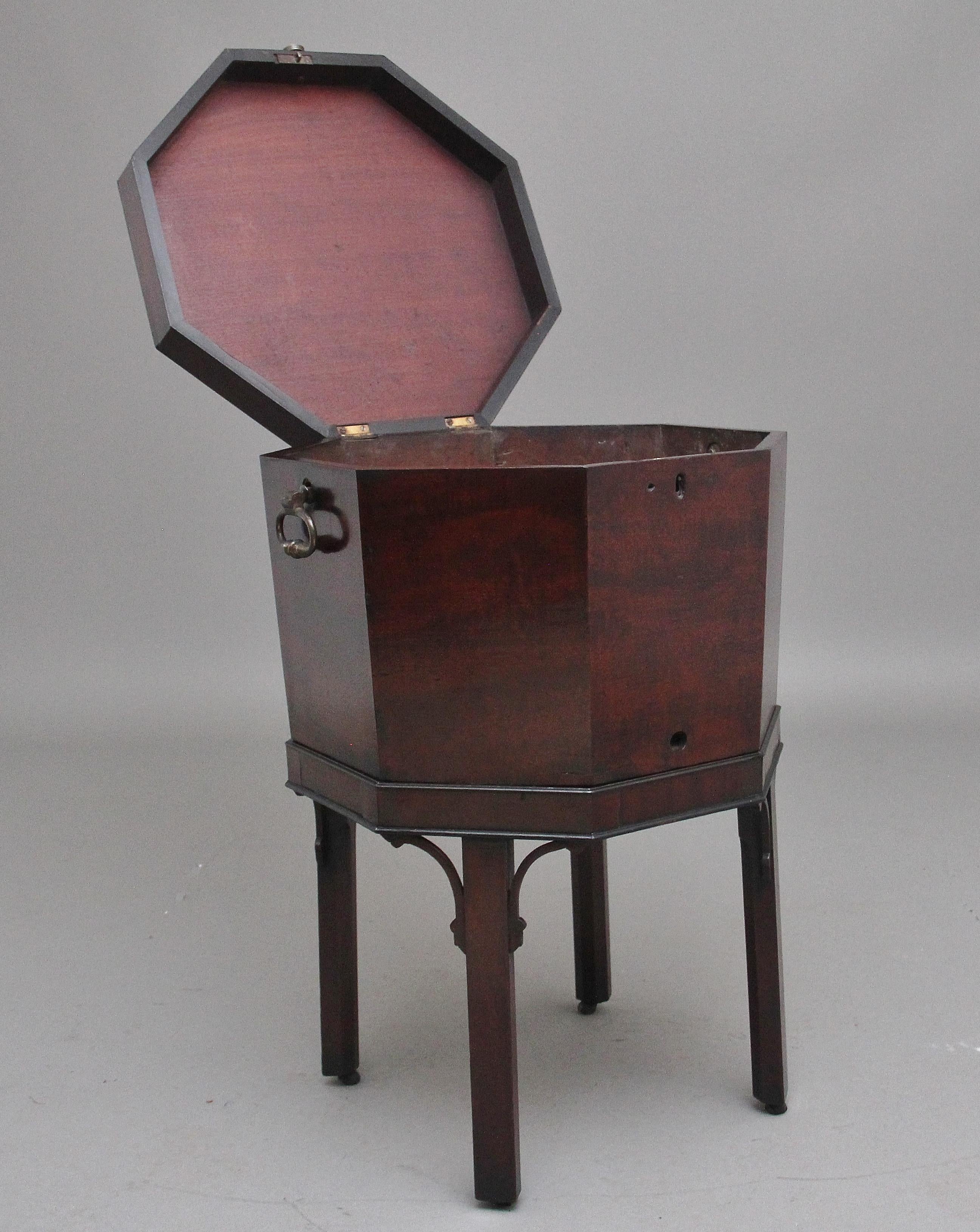 18th Century mahogany octagon shaped wine cooler / cellarette, the hinged shaped top lifting up to reveal a lead lined interior for storage of various alcoholic beverages, the base having brass carrying handles to the sides, standing on square legs