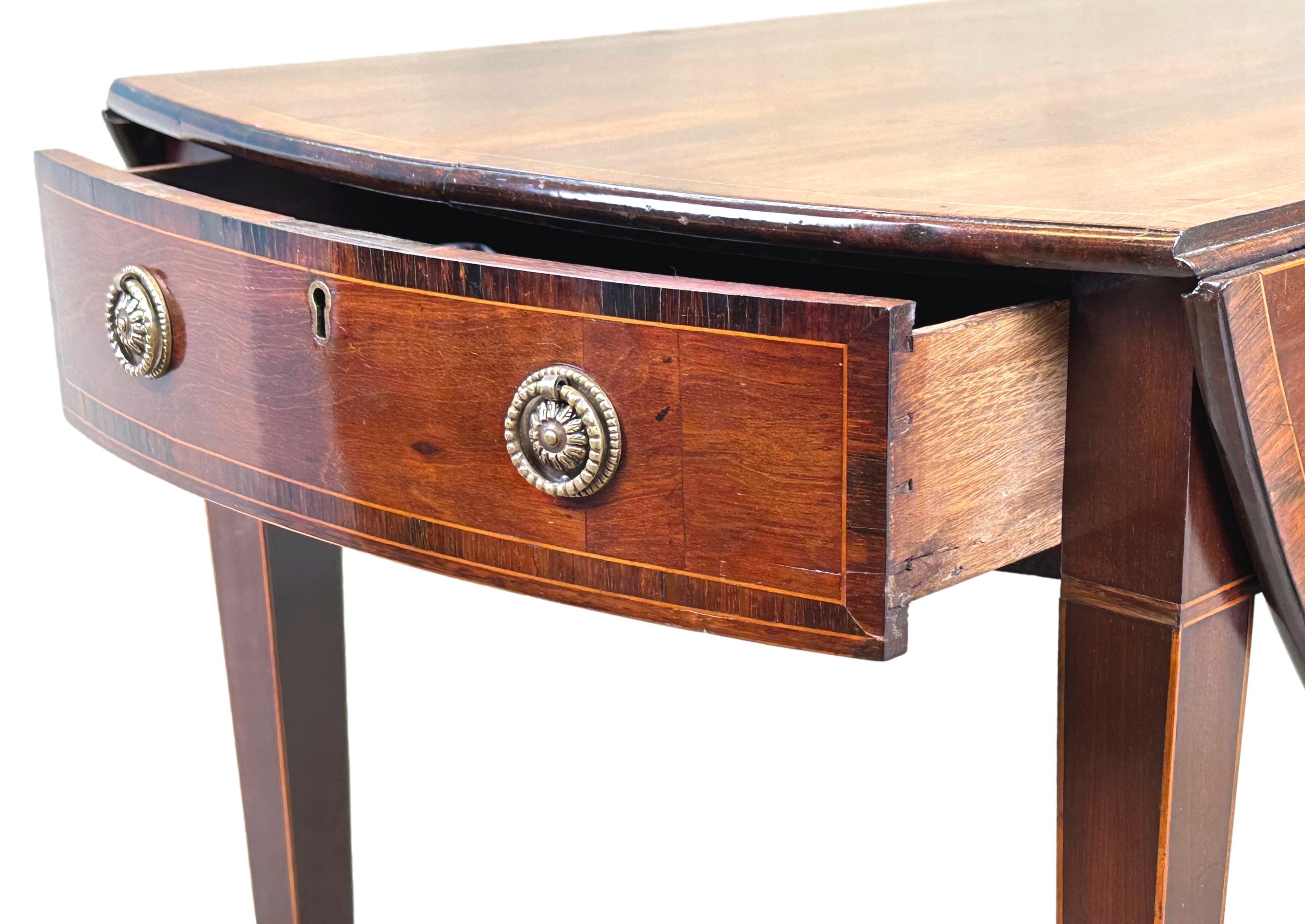 A very good quality Georgian, 18th century, mahogany oval Pembroke table, having well figured top with two drop flaps and crossbanded decoration, over one frieze drawer opposed by one false drawer to reverse with replacement brass handles, raised on