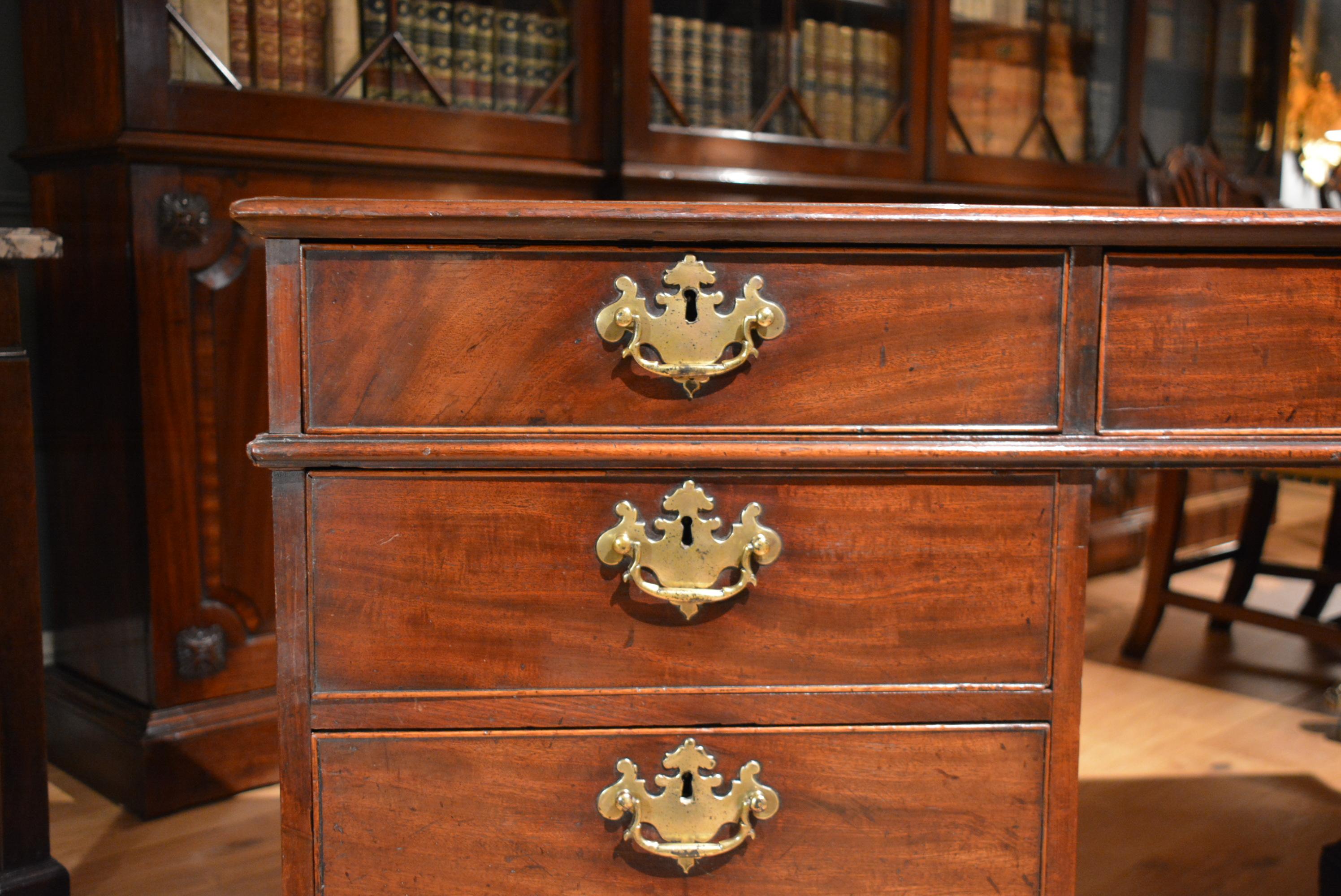 George II mahogany freestanding partners desk with the same configuration of drawers to both sides.
The patination and color are excellent, the brasses are all original, and the leather is very nice, old, soft, but not at all tatty.