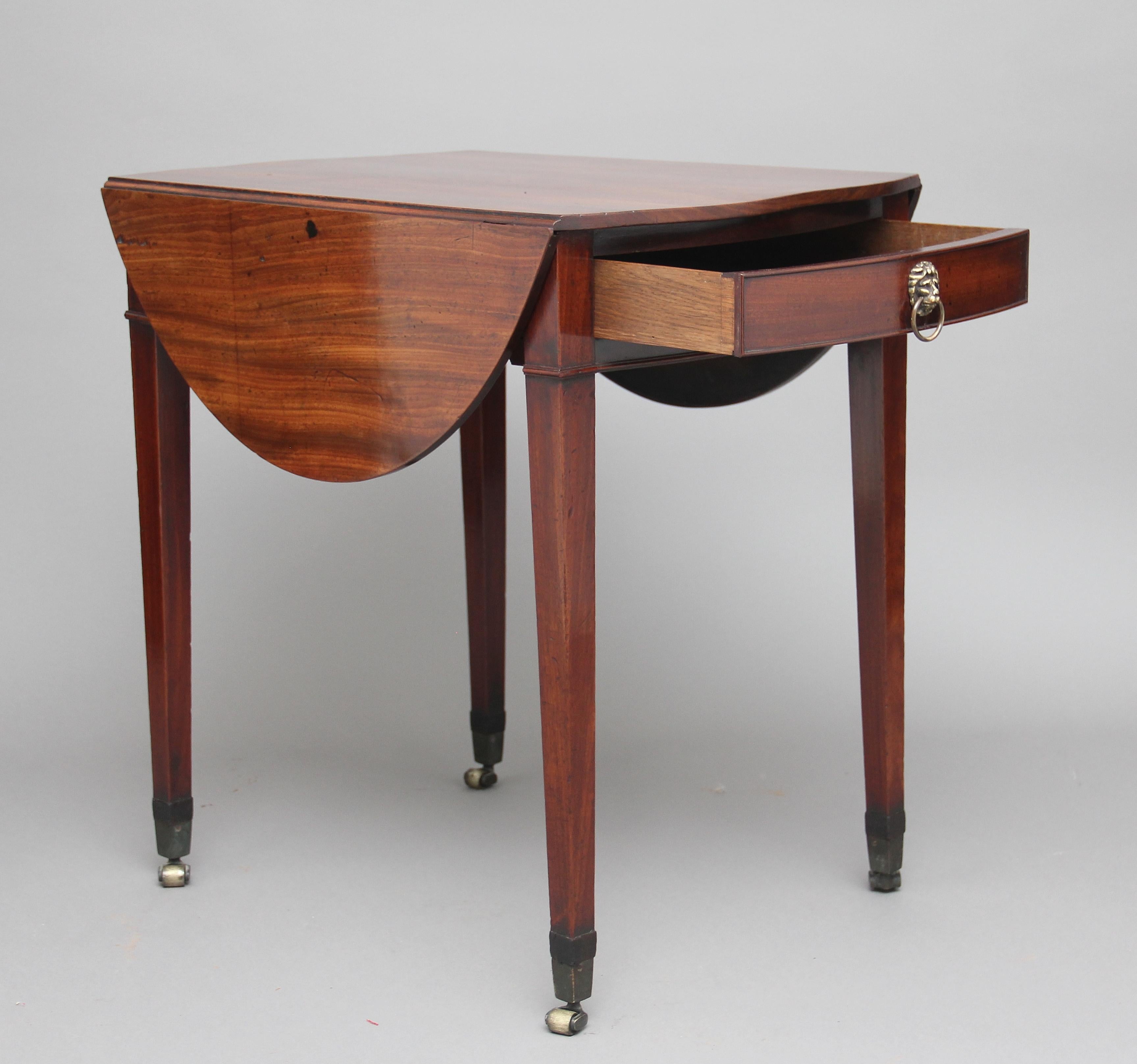 18th century mahogany pembroke table, having a lovely figured solid mahogany top with drop leafs, a single oak lined drawer at one end with original brass lion head handle, supported on four square tapering legs terminating on brass castors, circa