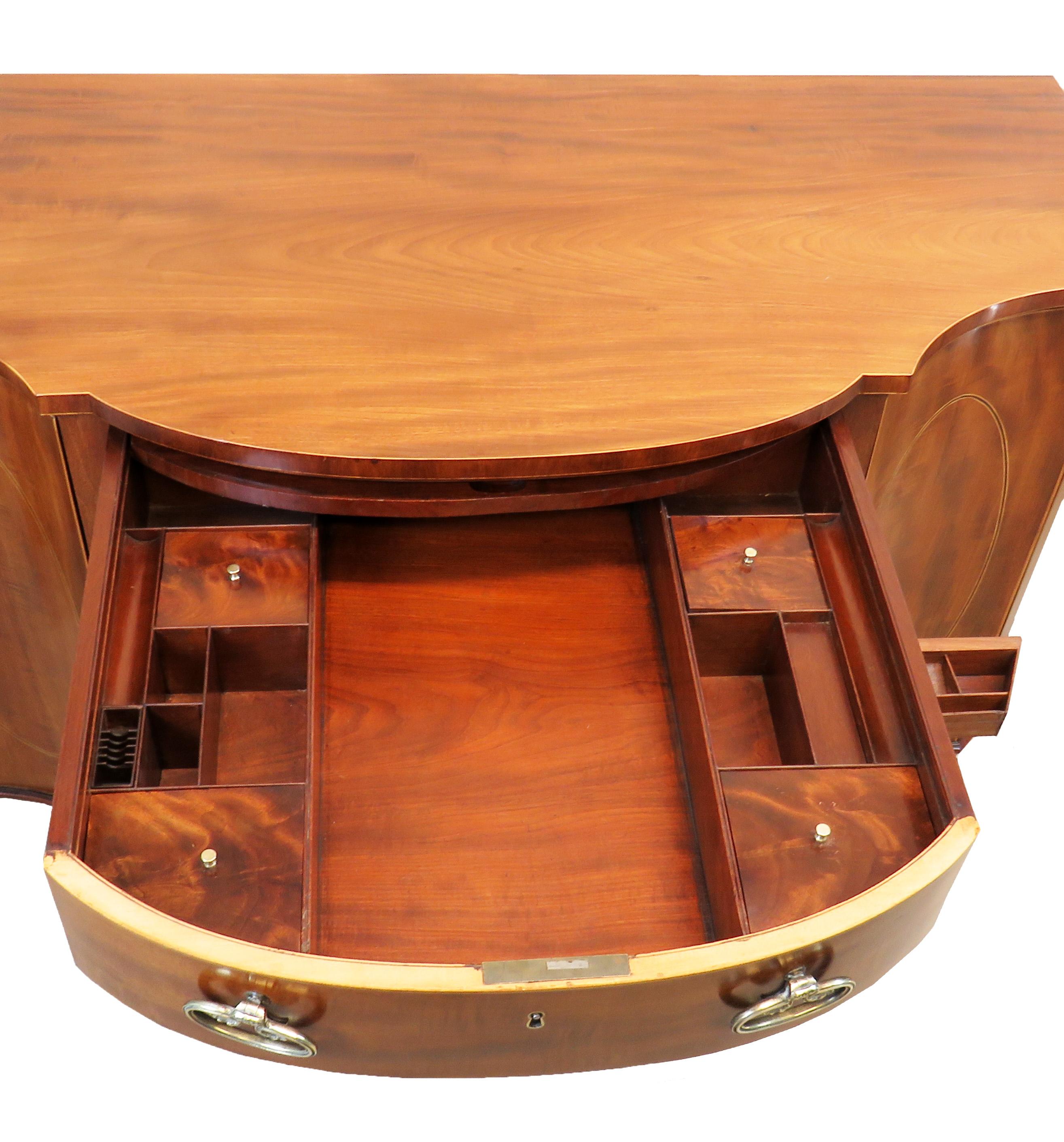 A very Fine quality late 18th century mahogany serpentine
Dressing table side cabinet having well figured top over
Central drawer with fitted interior retaining original brass
Handles flanked by curved cupboard doors raised on
Elegant square