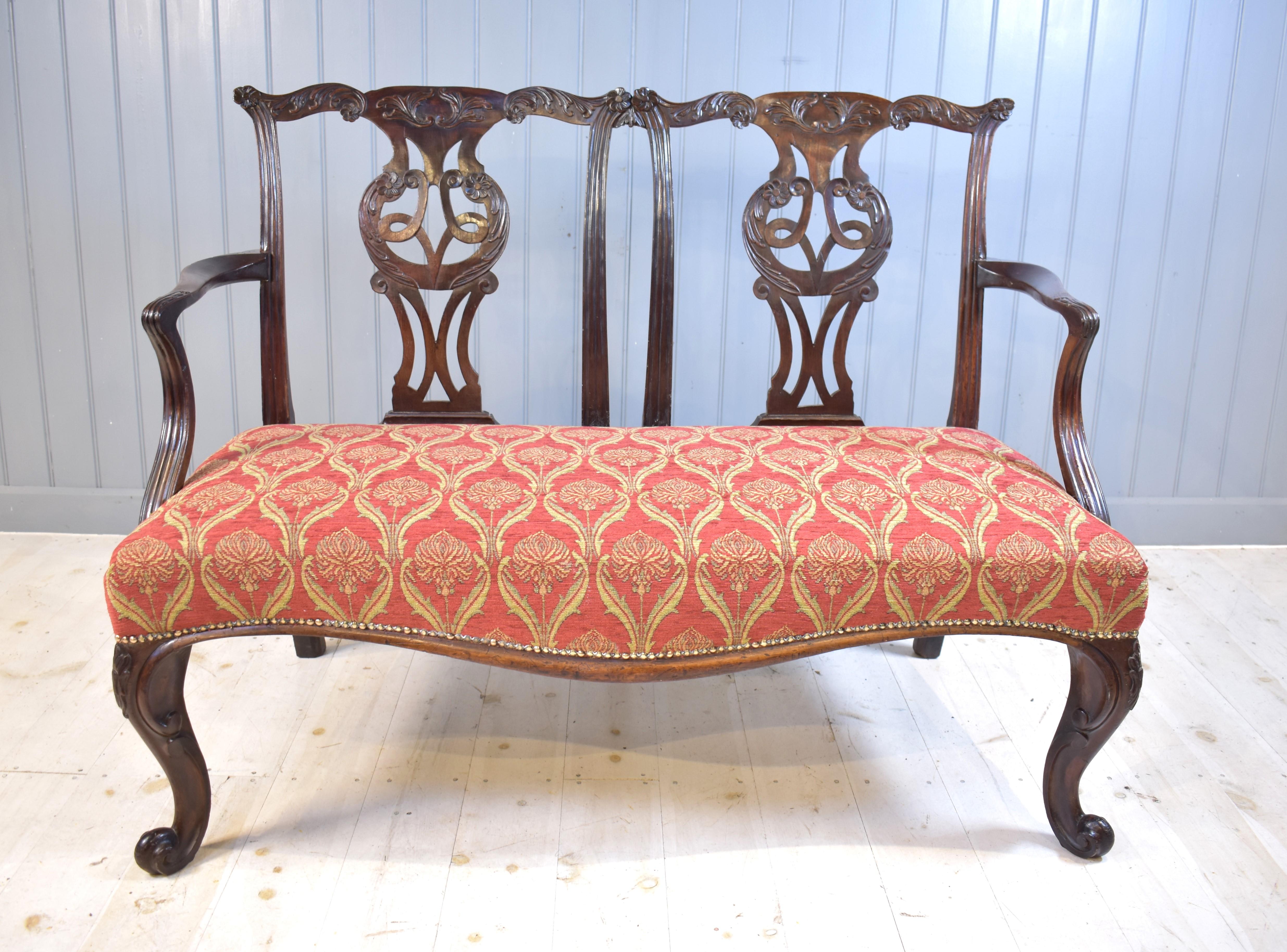  George the third mahogany cabriole legged, ribbon-back two chair settee. This piece is of top quality with no repairs and therefore a rare piece. The carving is very fine.  It is similar to the chairs found in Chippendale's Director and dates from