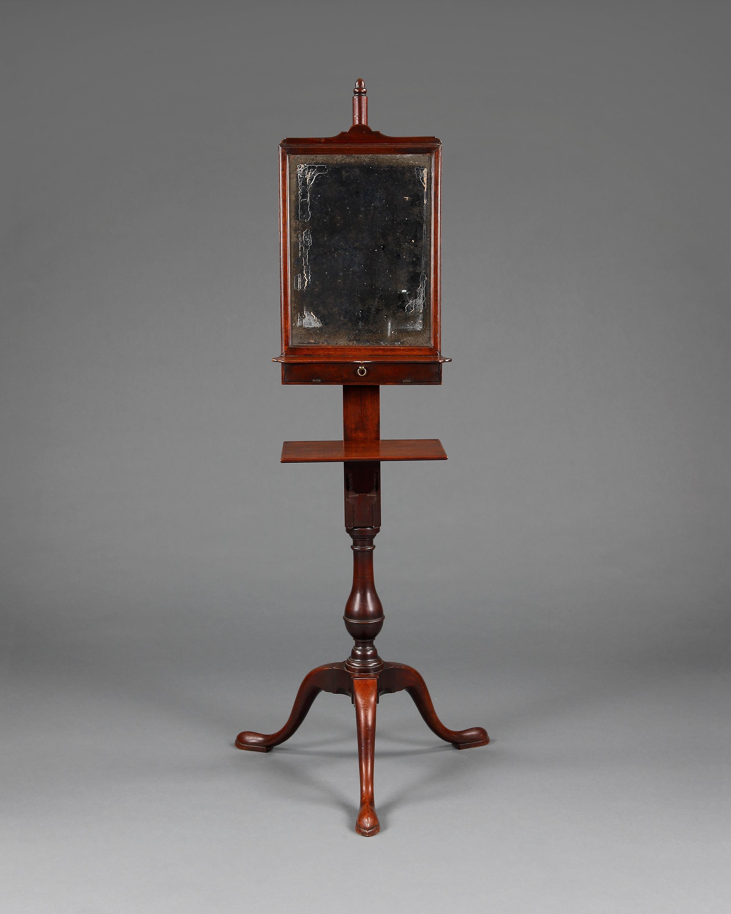 A rare and outstanding George II period mahogany tripod base shaving stand. Raised on three pointed pad feet, baluster shaped column. Having a fold down section which holds the shaving bowl and another section for the razors. Above is the