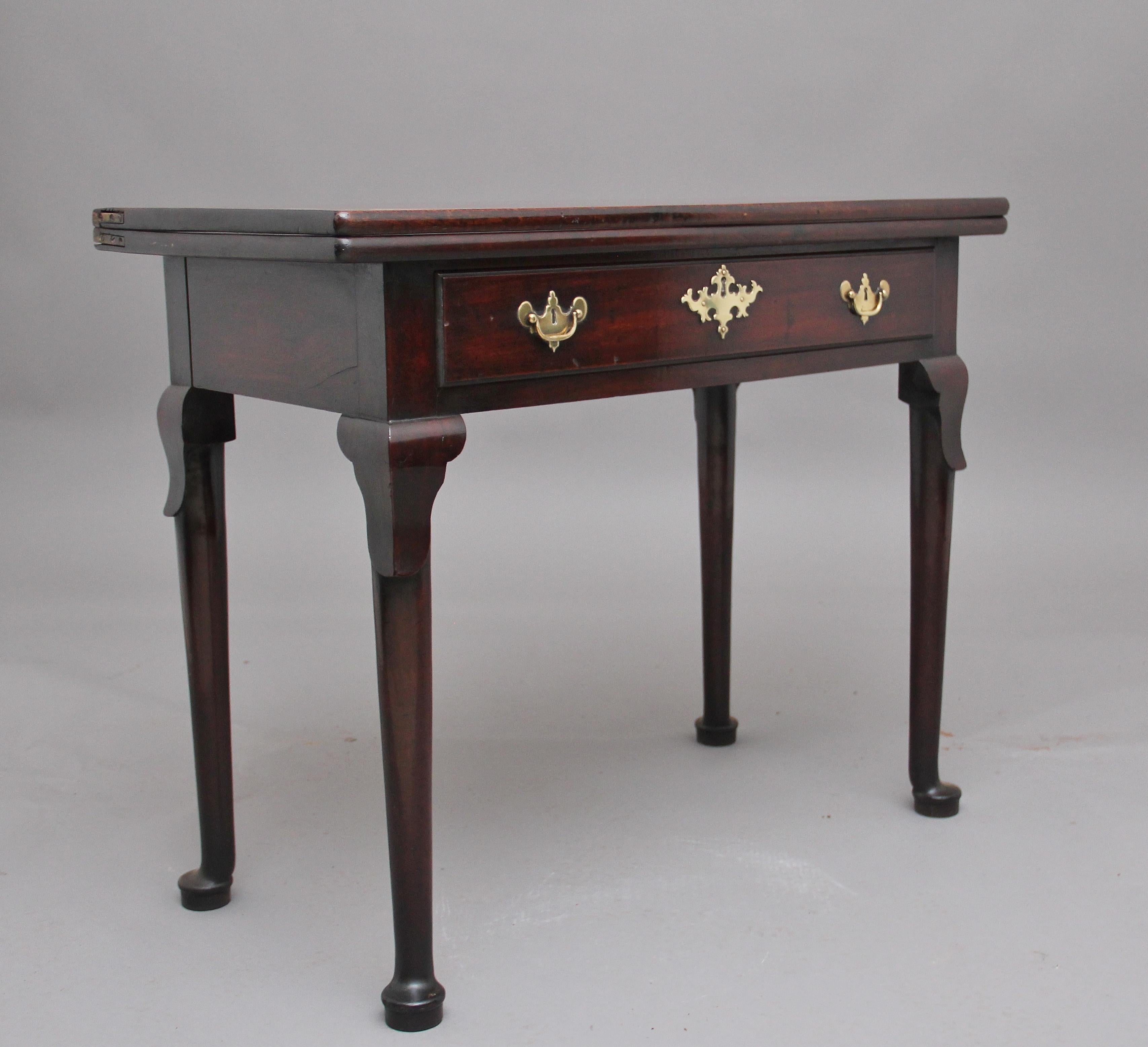 18th century mahogany tea or side table, having a solid hinged flip over top above a drawer to the frieze with original brass plate handles and escutcheons, standing on turned legs terminating on a pad foot, circa 1780.