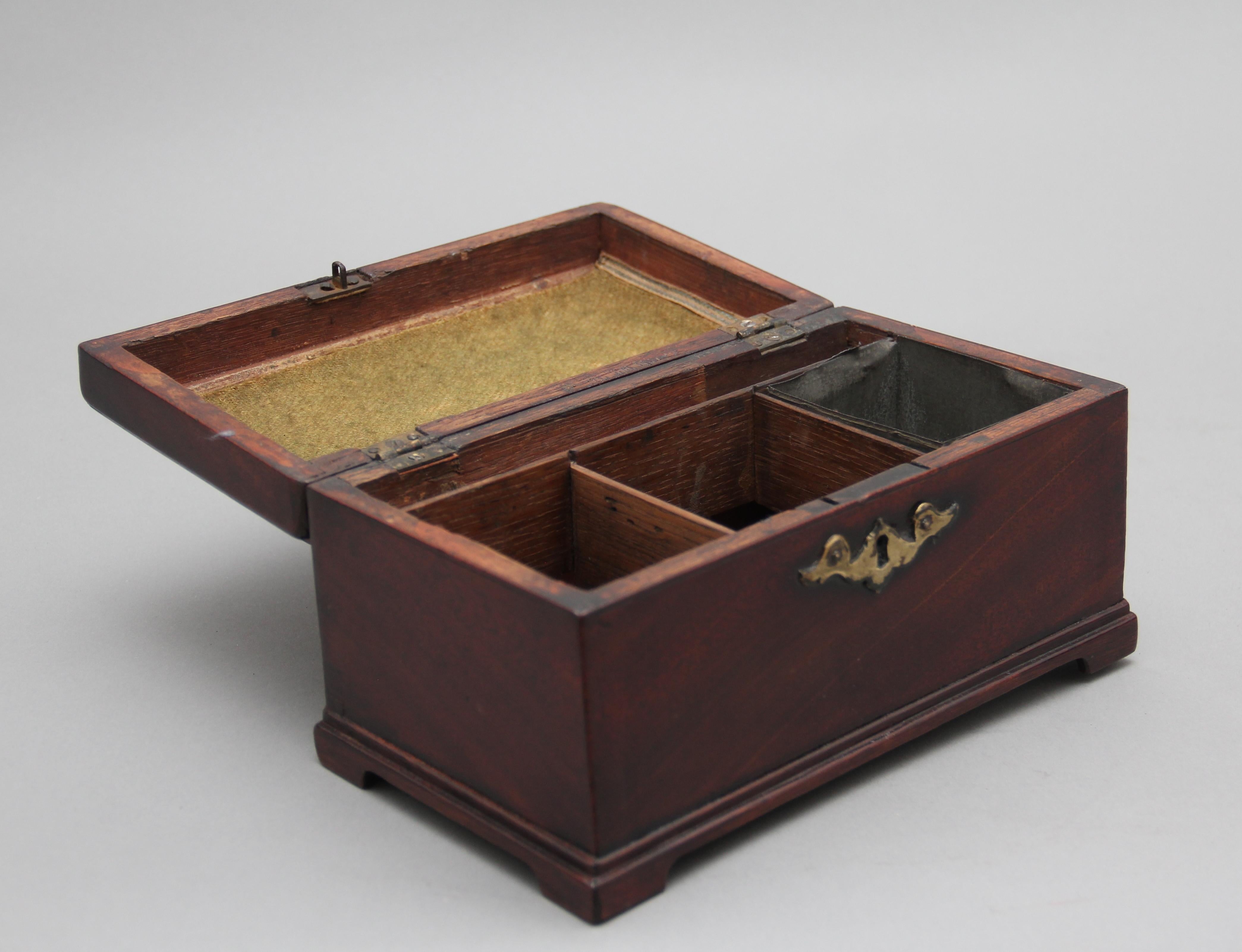 18th century mahogany tea caddy in the Chippendale style, having the original brass swan neck handle and escutcheon, the hinged top opens to reveal three divisions, with one division having the original tin canister for the tea, standing on small