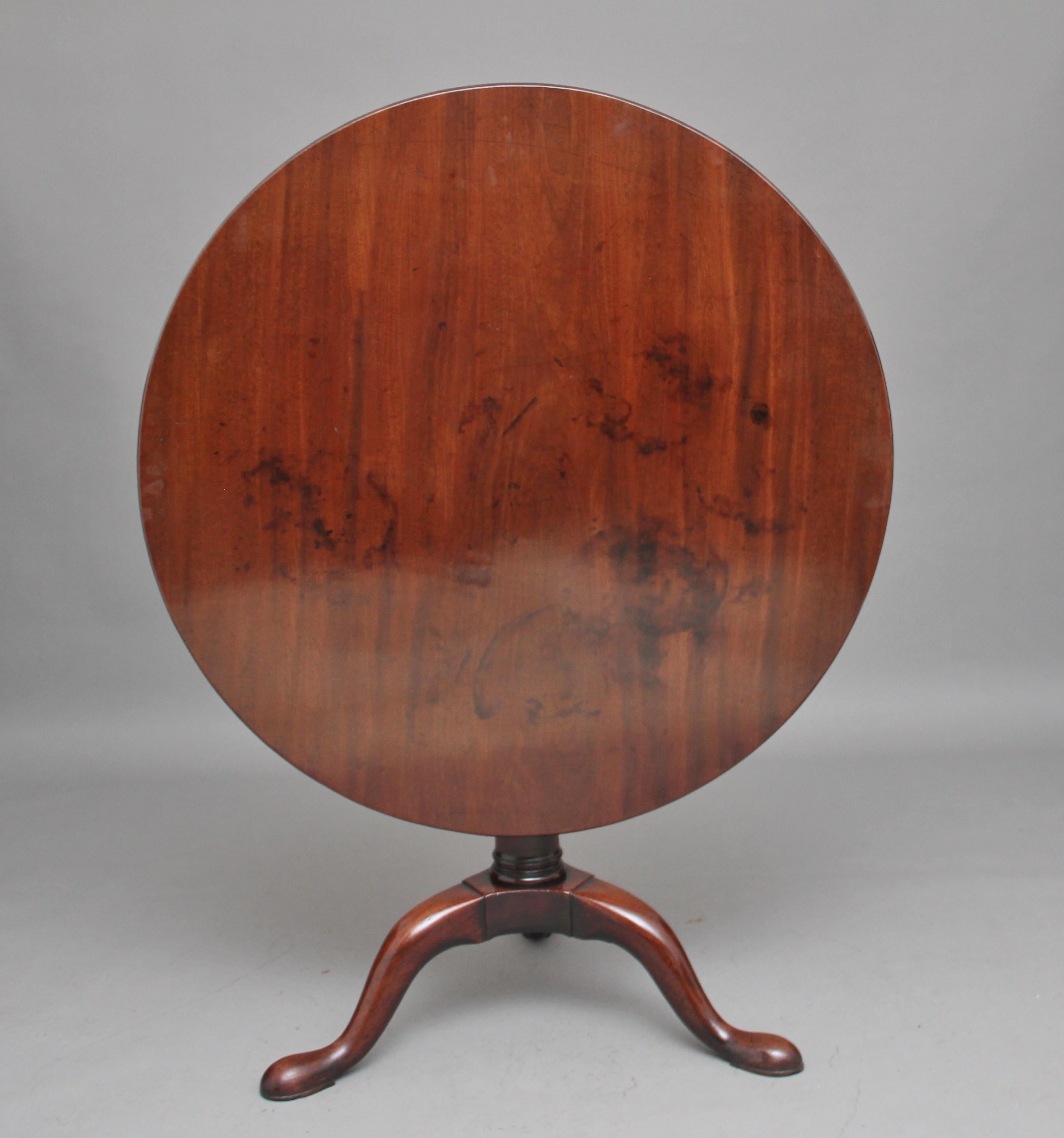 18th century mahogany tripod table of large proportions, the circular mahogany top sitting on a birdcage mount so you can turn the top without turning the base, supported on a turned column terminating with three slender shaped legs, circa 1780.
 
