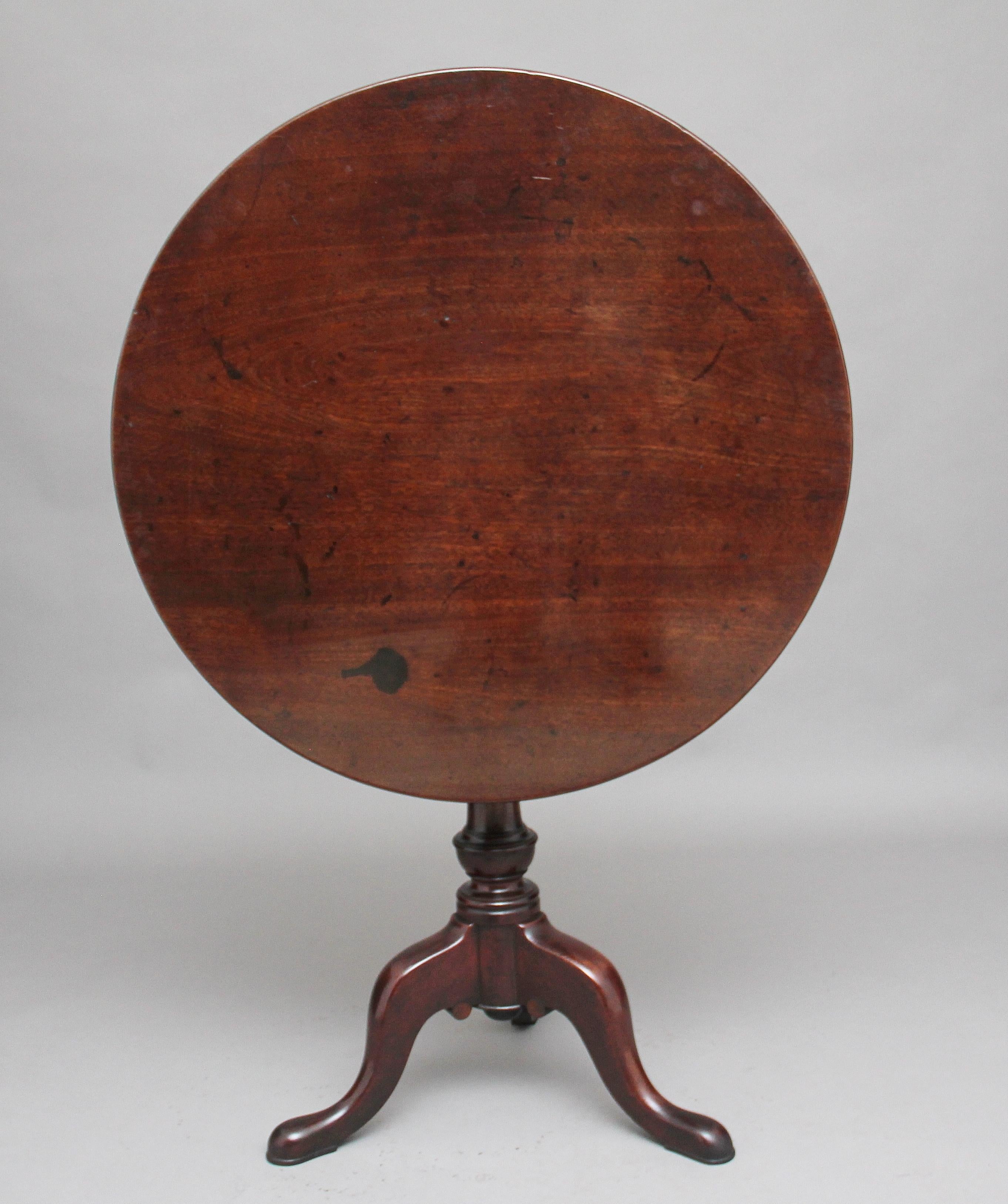 18th century mahogany tripod table, the circular mahogany top sitting on a birdcage mount so you can turn the top without turning the base, supported on a turned column terminating with three slender shaped legs, circa 1780.
