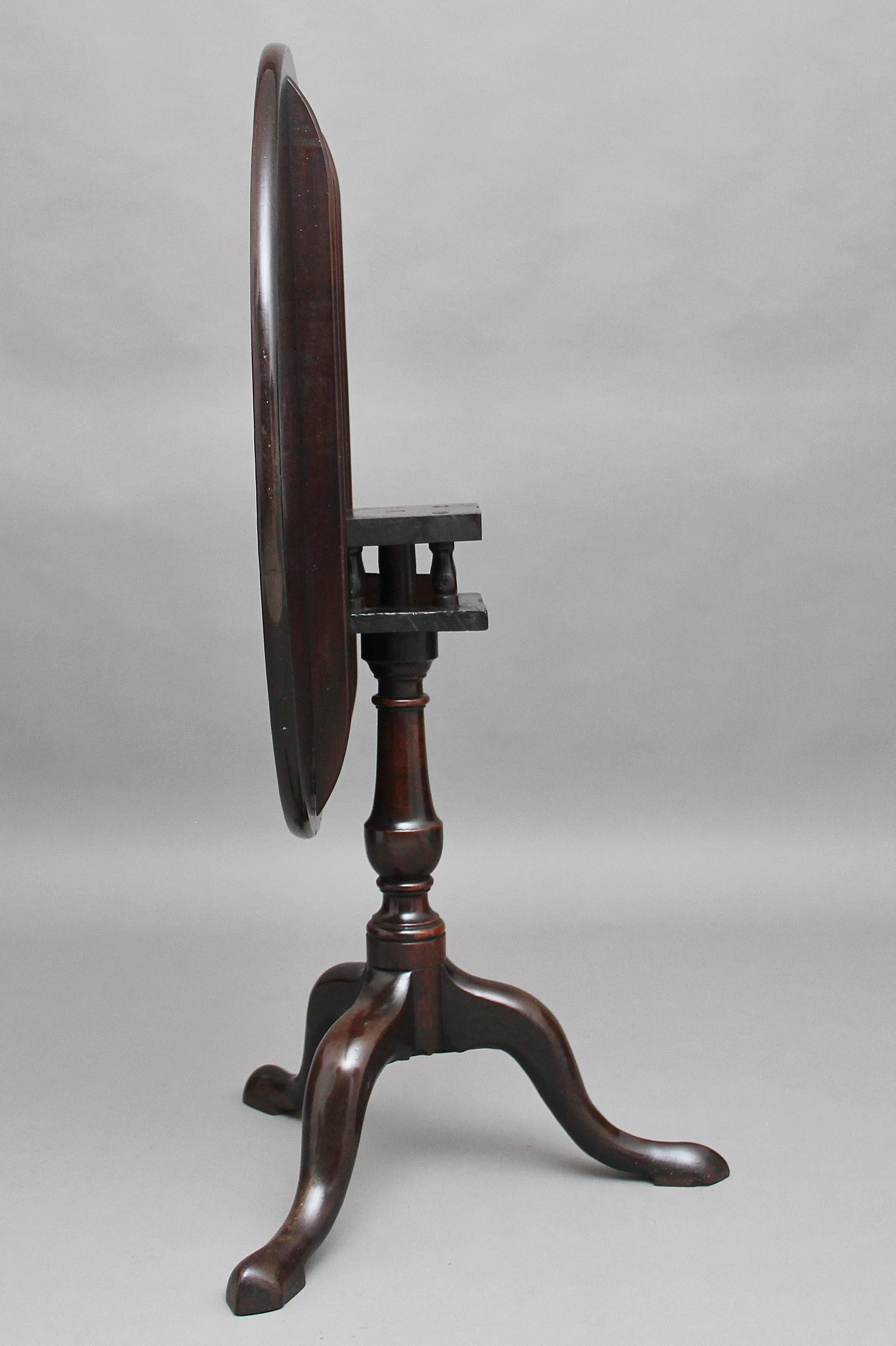 18th century mahogany tripod table, the circular mahogany top sitting on a birdcage mount so you can turn the top without turning the base, supported on a turned column terminating with three slender shaped legs, circa 1780.
     