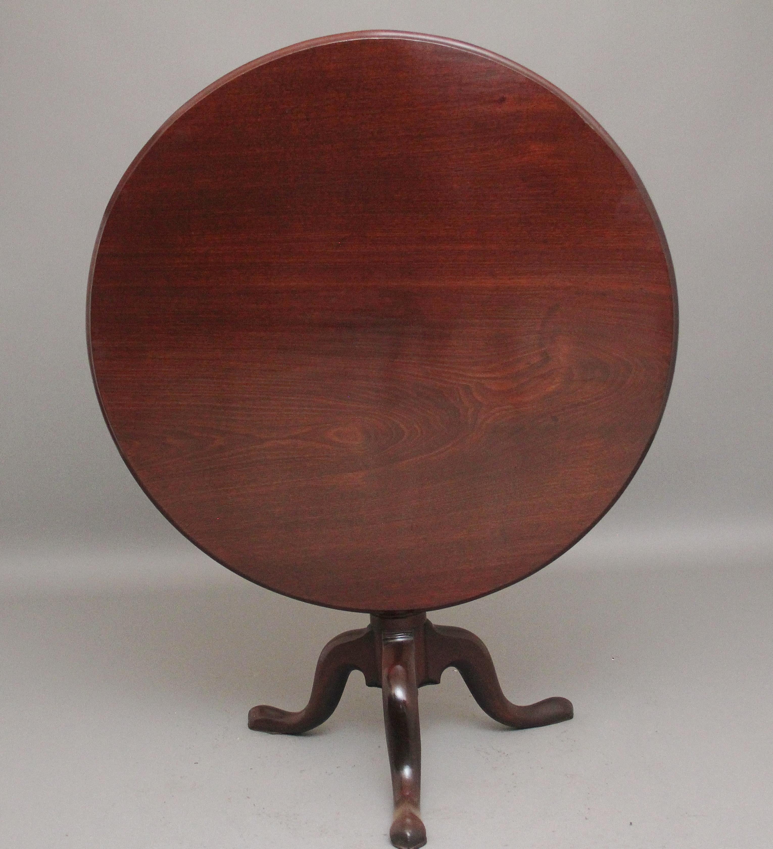 A large 18th Century mahogany tripod table, having a lovely figured circular top, supported on wonderfully turned and carved column terminating with three slender shaped legs, in fantastic condition and having a nice warm mahogany colour.  Circa