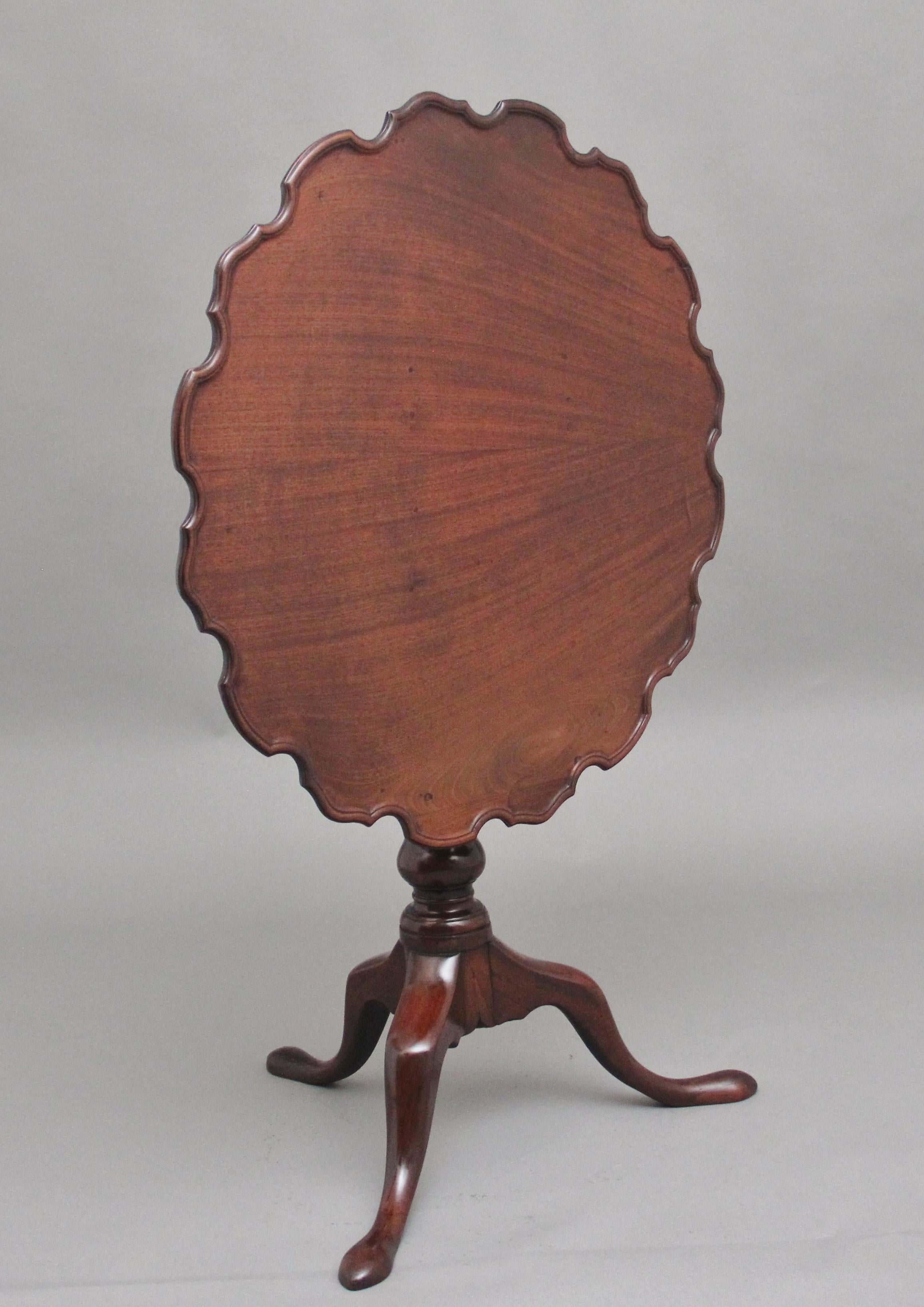 18th Century mahogany tripod table having a wonderfully figured top with a piecrust edge, supported on an elegant turned column terminating with three slender shaped legs.  Having a lovely warm rich mahogany colour and in excellent condition.  Circa