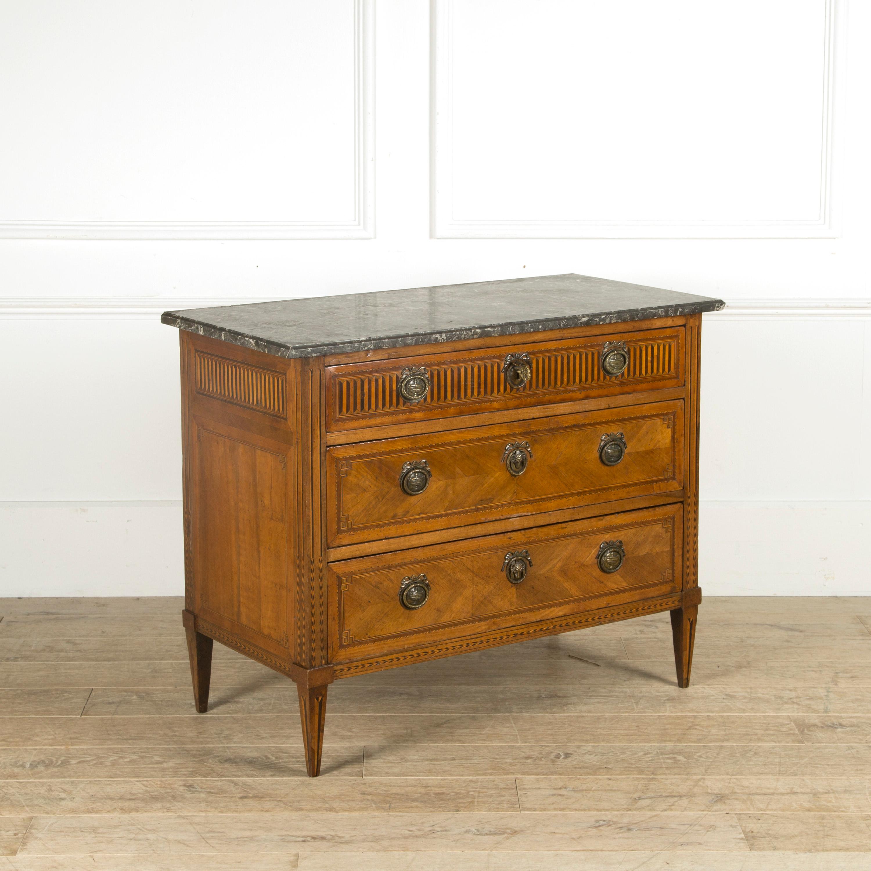 Period Louis XVI walnut commode, with three lockable drawers. Stunning decorative marquetry including tulipwood, pearwood, rosewood and acacia. Fabulous brass handles and lock surrounds with rams head covers. Original Bardiglio Carrara marble top,