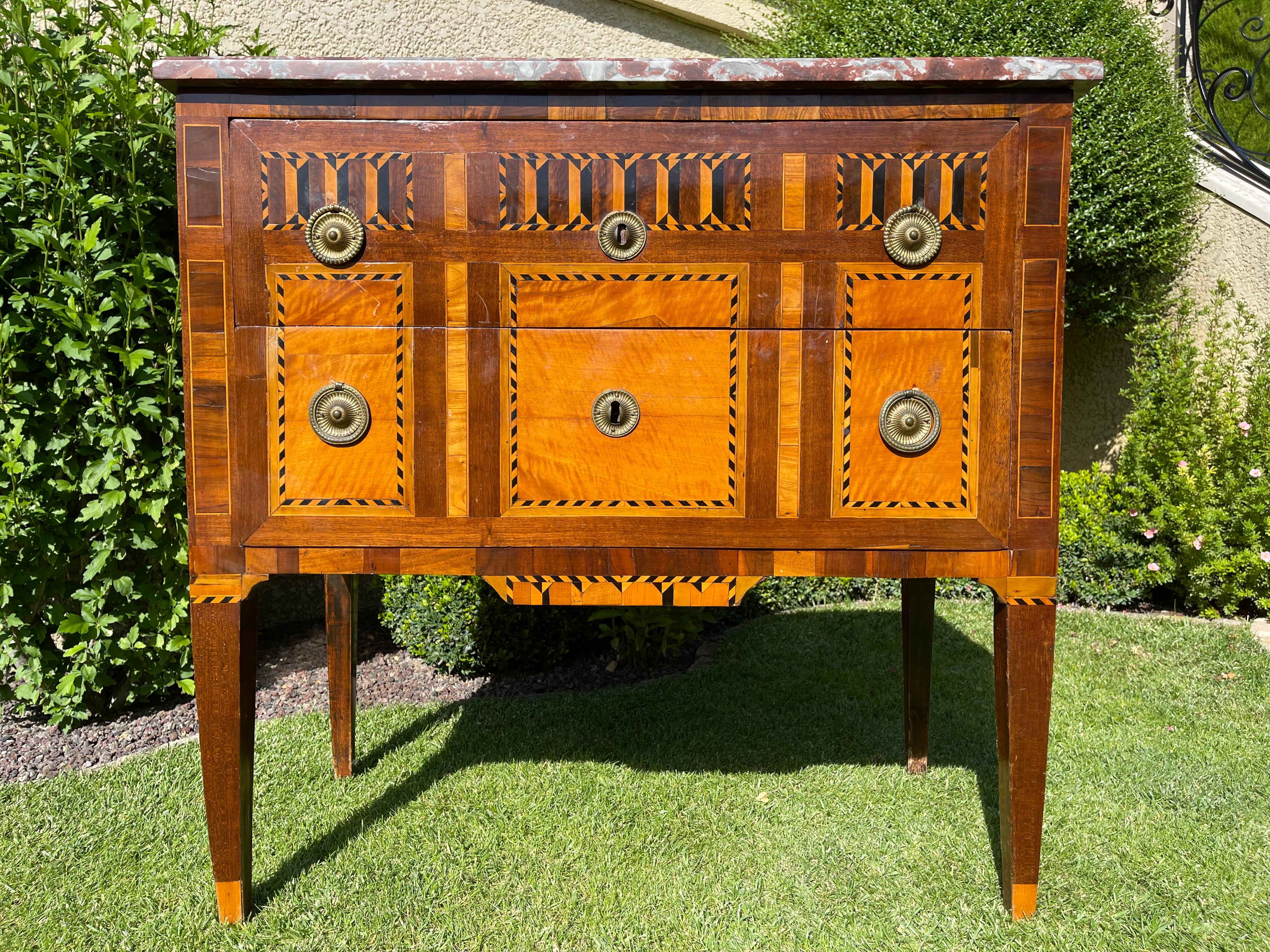 Elegant Louis XVI period marquetry commode with 2 drawers and marble on the top. Bronze drawer handles. Very good quality piece and good condition. 18th century.