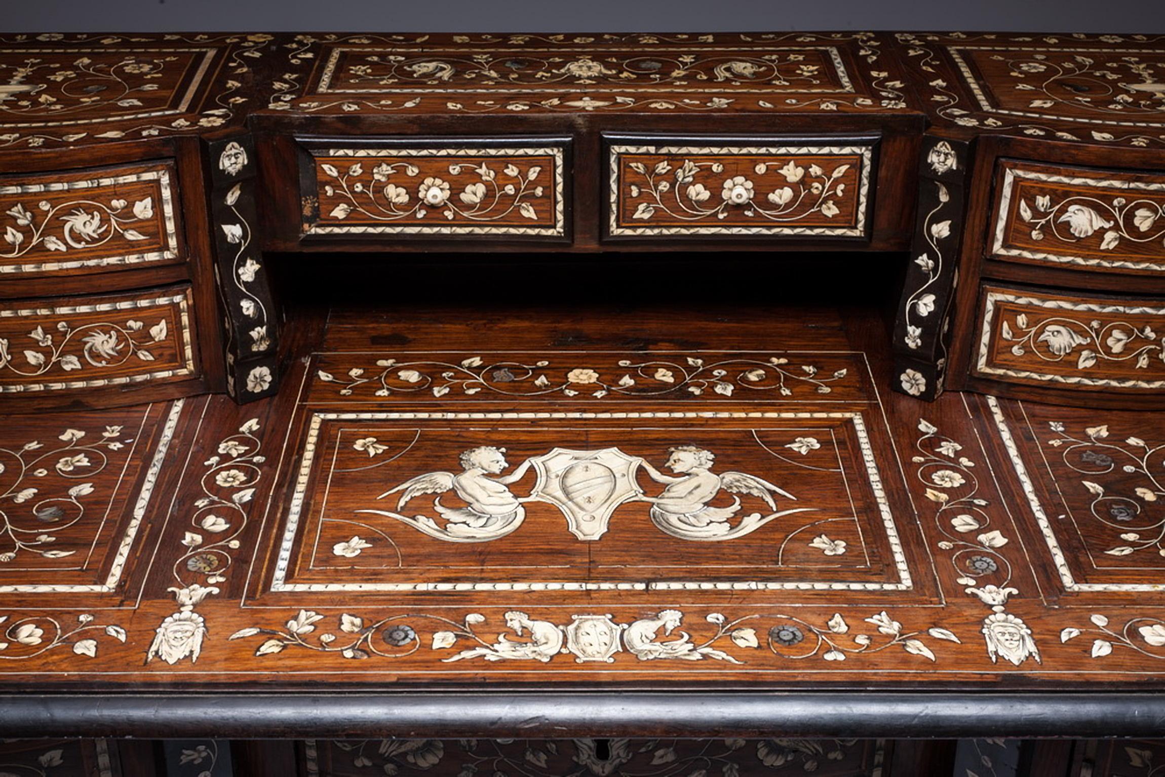 A wonderful Italian inlaid bureau Mazarin in the style of Louis XIV

The shaped front desk of burl walnut and satin wood inlay with convex drawer fronts and canted corners is intricately inlaid with pearl in floral and foliate motif with putti and