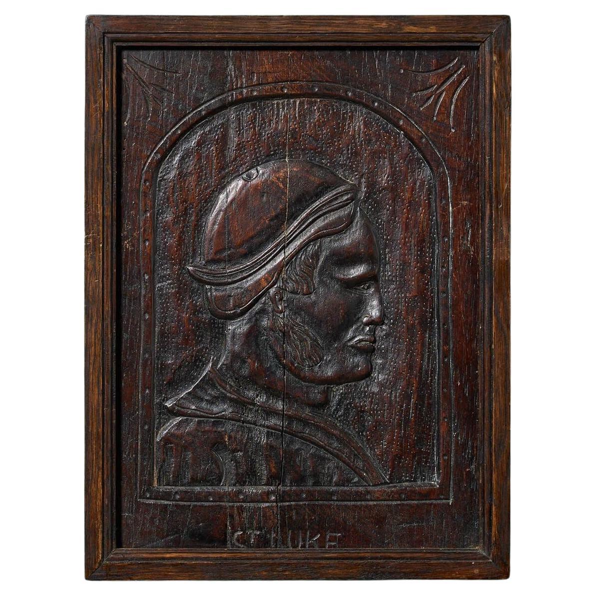 18th Century Medieval Style Carved Oak Portrait Panel of St Luke For Sale