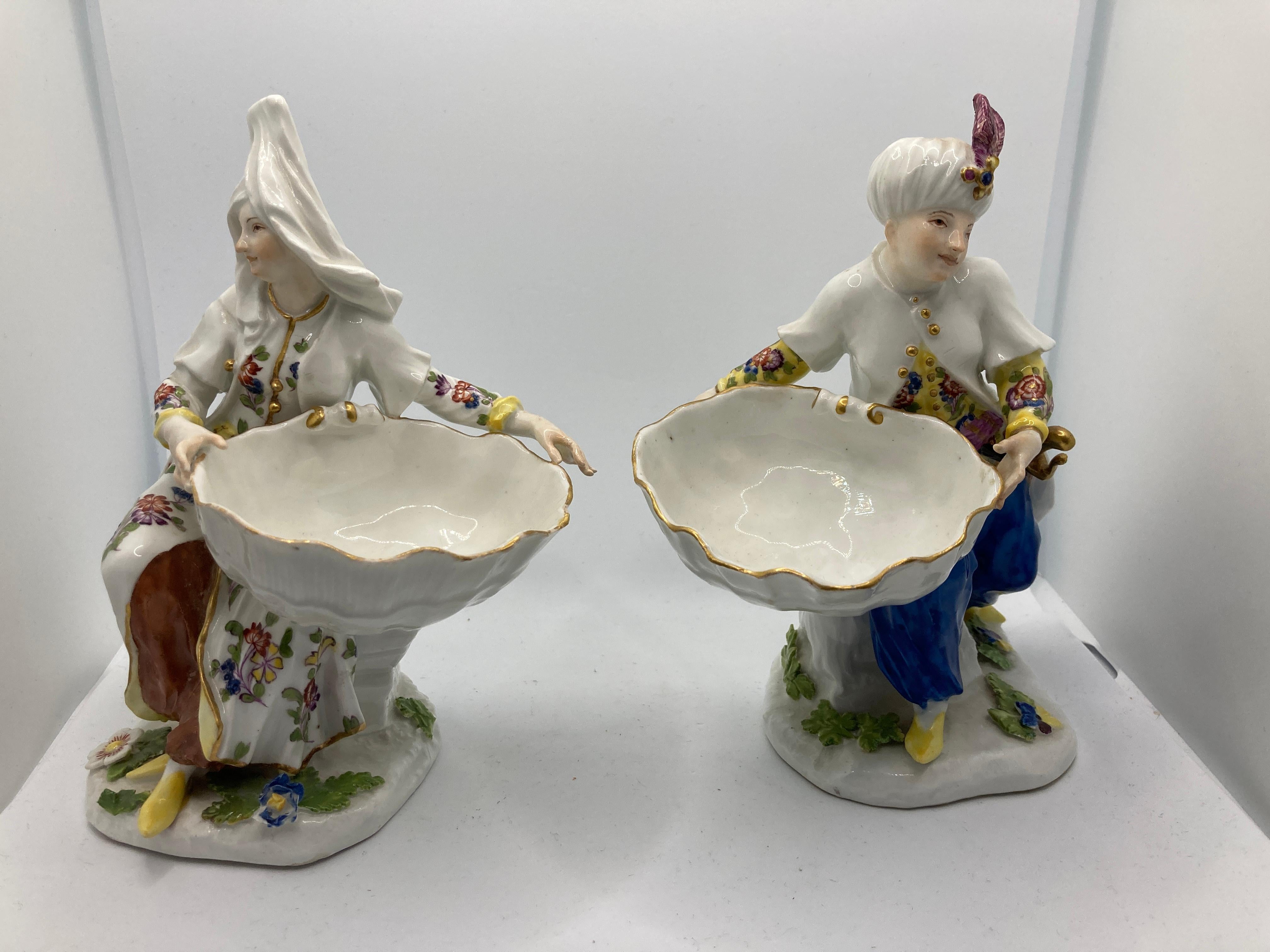 18th Century Meissen Porcelain, Pair of Turkish figures holding sweetmeat / table salt bowl. These sweetmeat figures were made around 1745, the original models being done by J F Eberlain and show the fashion for Orientalism popular at the time.