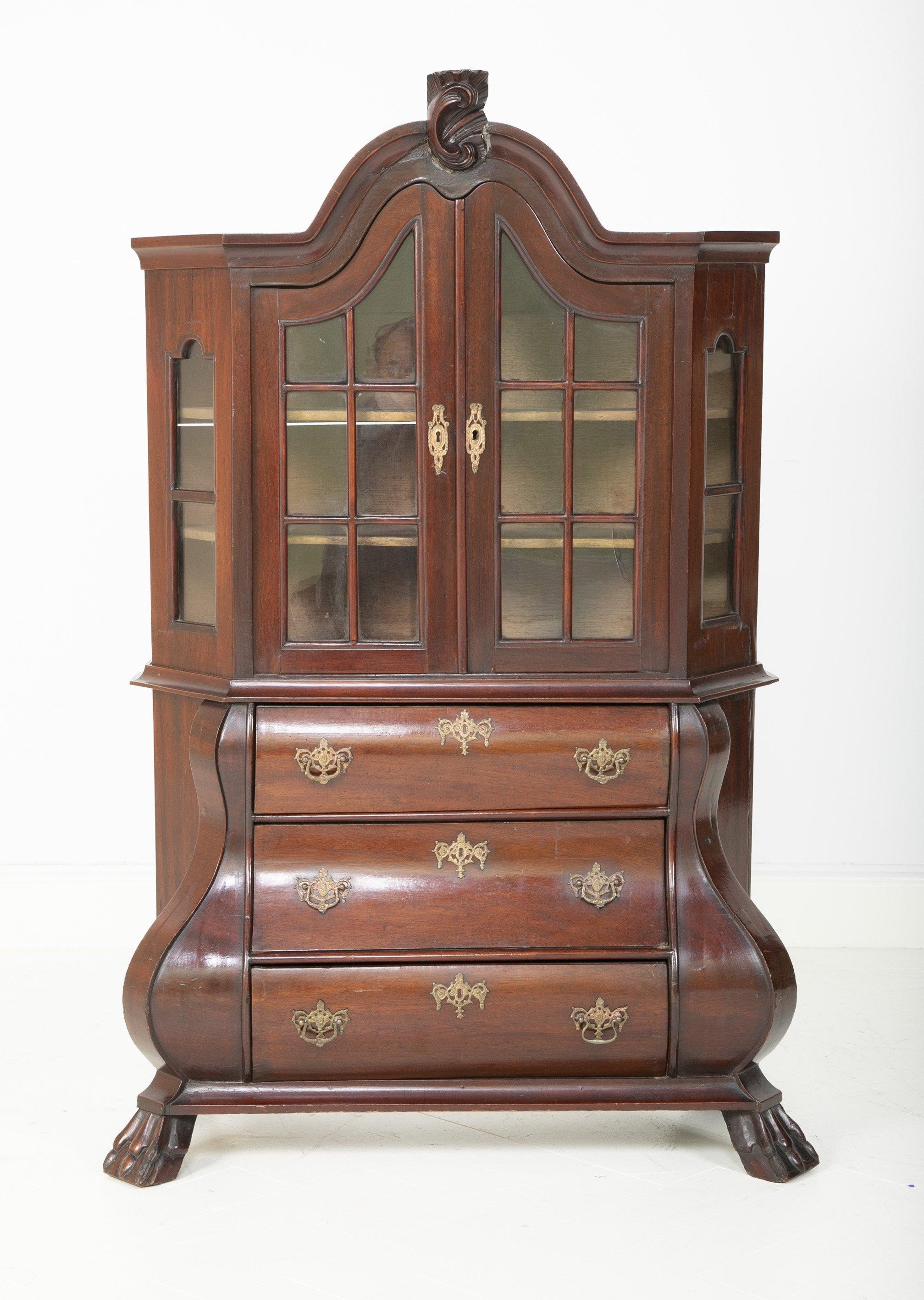 A late 18th-century diminutive Dutch kettle base paw foot bookcase with arched crest and glazed double doors and original pulls, circa 1790.



We are proud of our long-standing partnership with George N Antiques who specializes in fine authentic