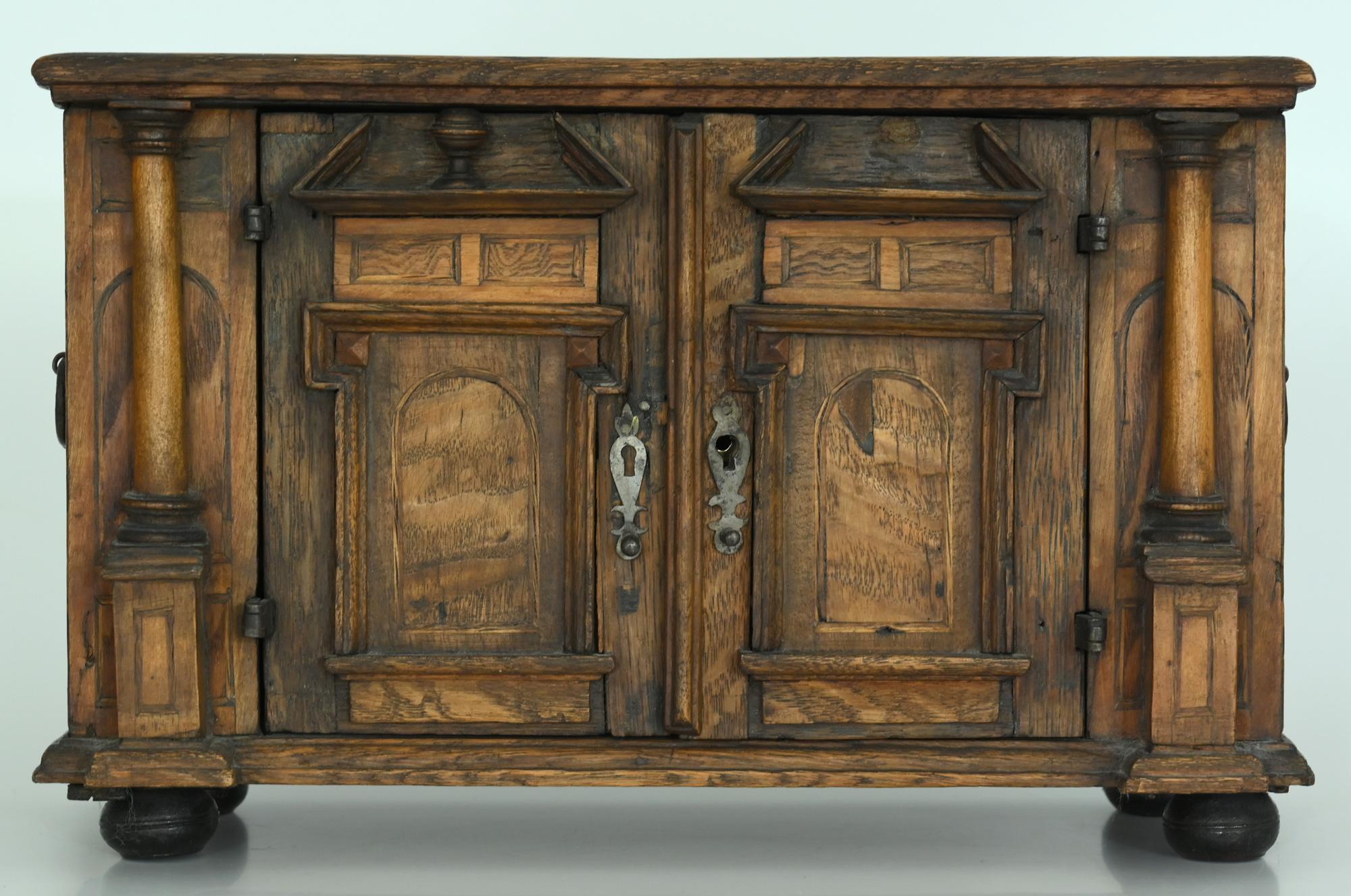 A particularly beautiful example of a model sideboard in the Renaissance style. It is made circa 1750 out of several different woods. The fittings and the lock are original, as well as the interior with the two compartments.
  