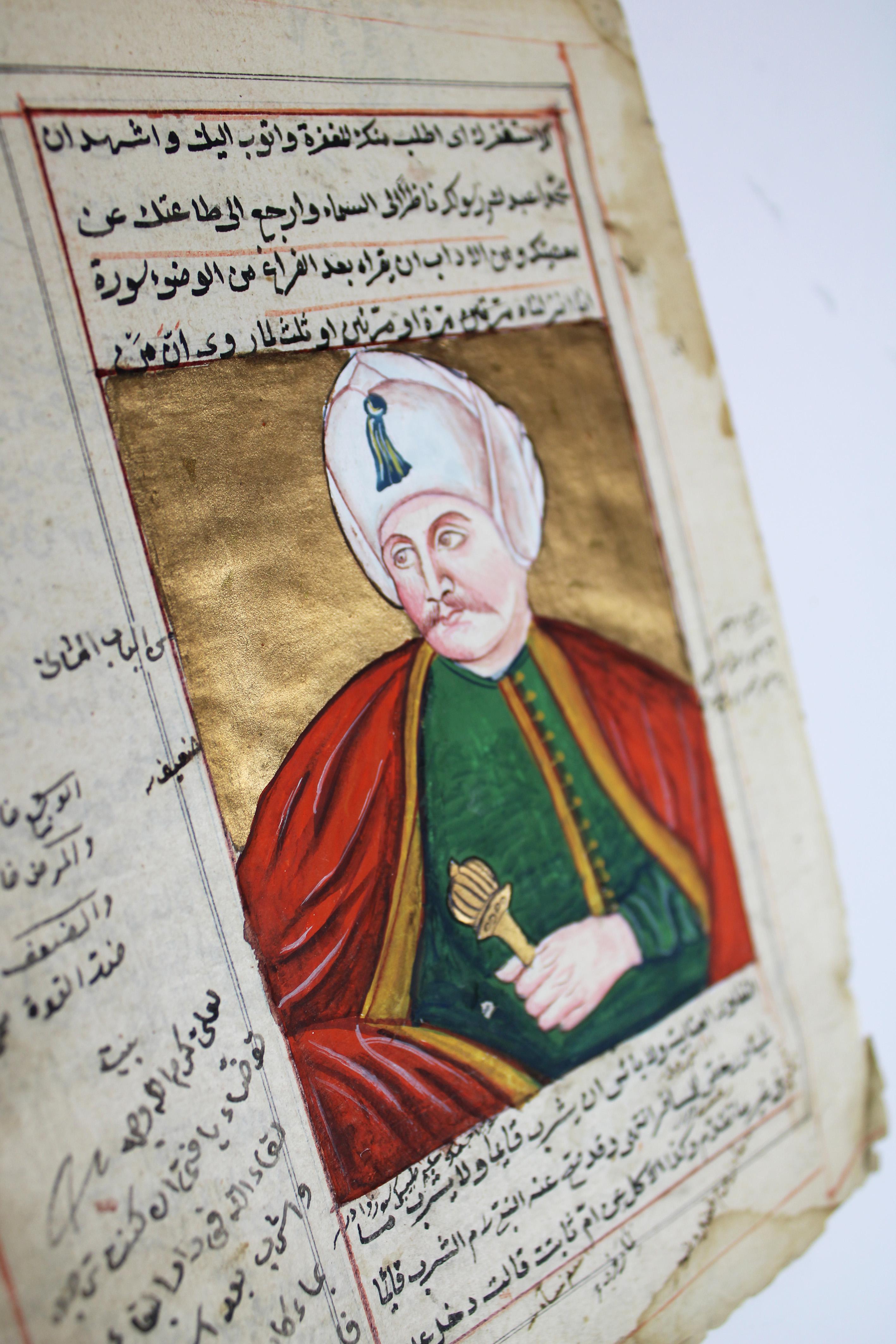 Presenting a captivating 18th Century Moghul Miniature, a page from an illuminated manuscript depicting an Ottoman Sultan adorned in a white turban and a red cloak, set against a golden background. This exquisite artwork is beautifully framed in an