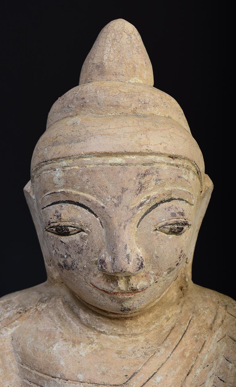 Burmese soapstone Buddha sitting in Mara Vijaya (calling the earth to witness) posture on a base.

Age: Burma, Mon Period, 18th century
Size: Height 34.5 C.M. / Width 22 C.M.
Size including stand: Height 41 C.M.
Condition: Nice condition