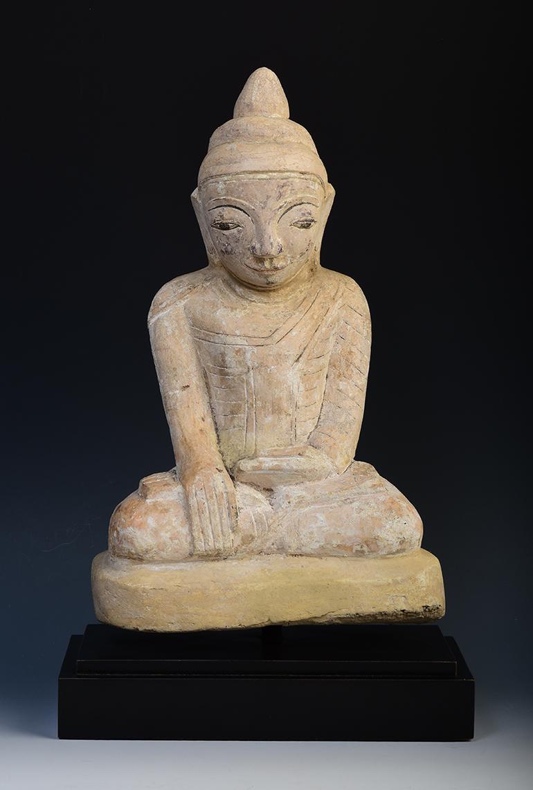 Antique Burmese soapstone Buddha sitting in Mara Vijaya (calling the earth to witness) posture on a base.

Age: Burma, Mon Period, 18th century
Size of Buddha only: Height 34.5 C.M. / Width 22 C.M.
Height including stand: Height 41 C.M.
Condition: