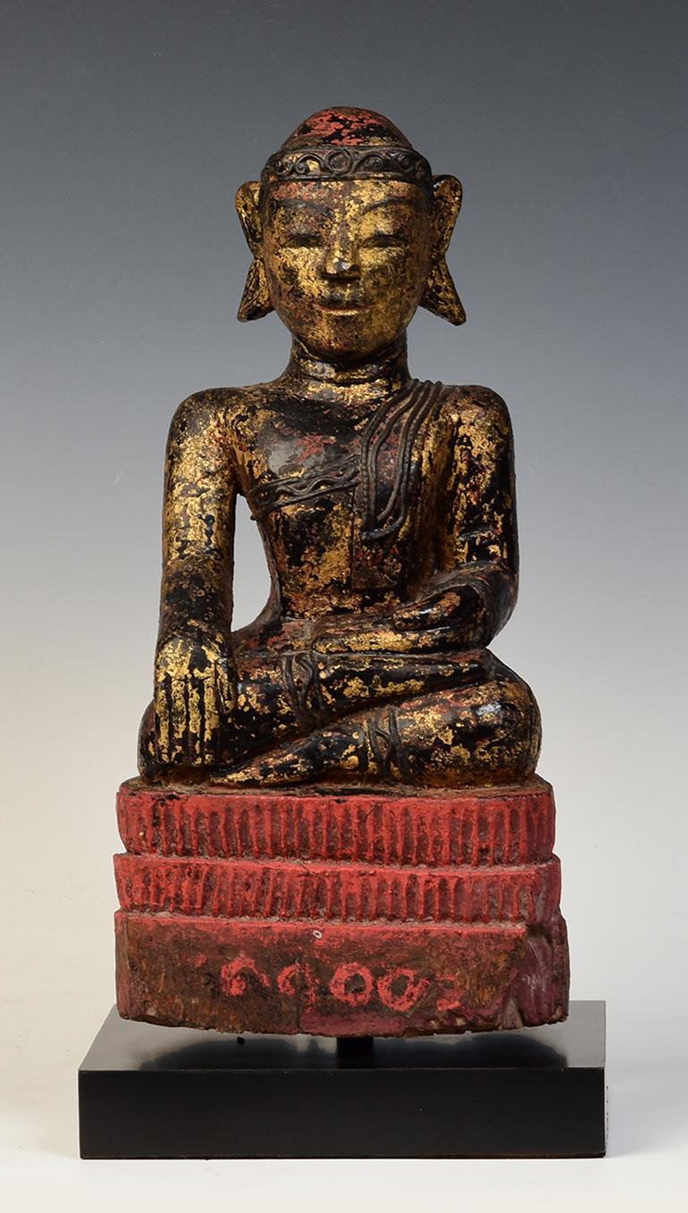 Burmese wooden Buddha sitting in Mara Vijaya (calling the earth to witness) posture on a base.

Age: Burma, Mon Period, 18th century
Size: Height 40 C.M. / Width 19.5 C.M.
Size including stand: Height 44.8 C.M.
Condition: Nice condition overall