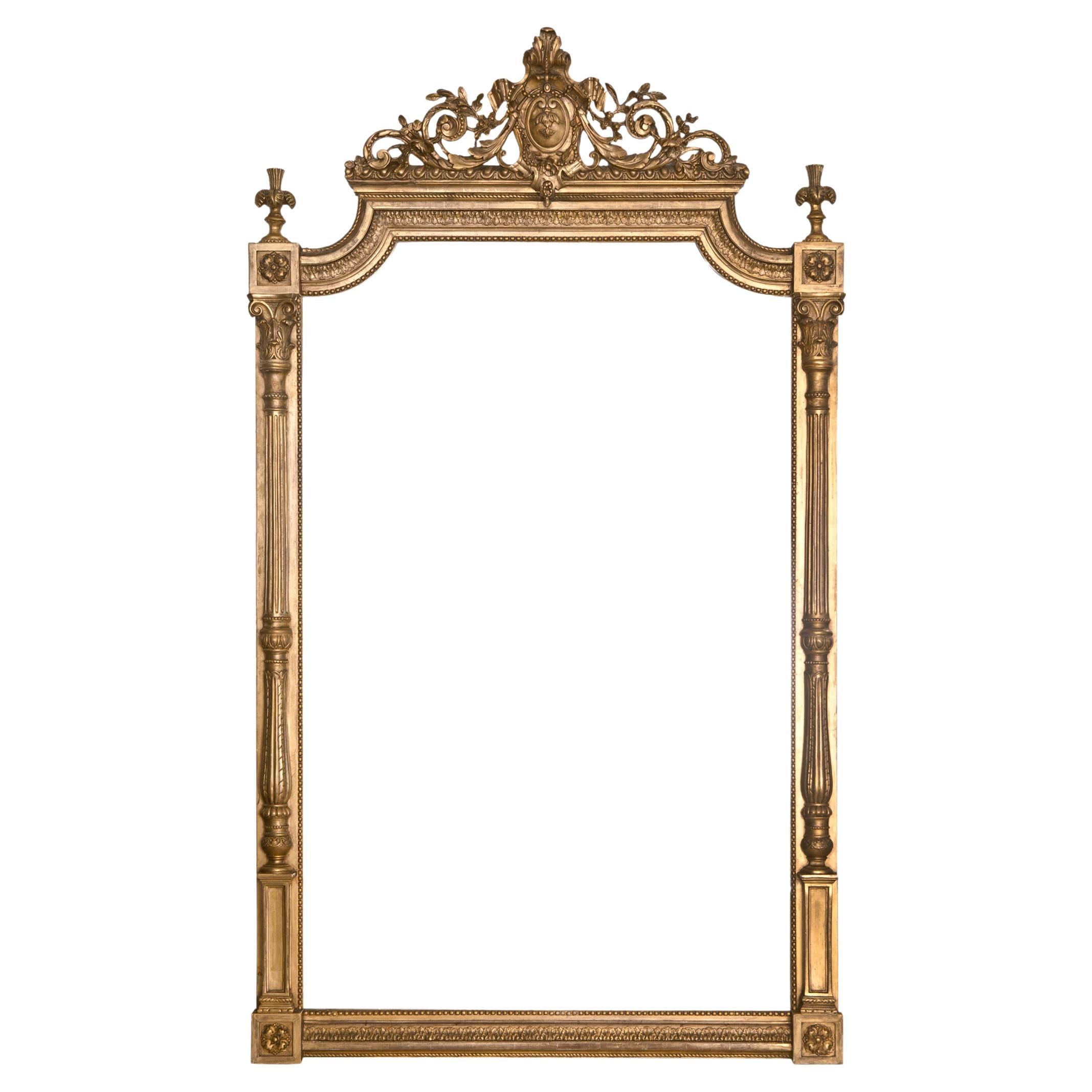 This magnificent giltwood mantle mirror is intricately carved with columns, medallions & delicate scrolls. The mirror & frame are as beautiful condition for the age. A stunning example of the period.