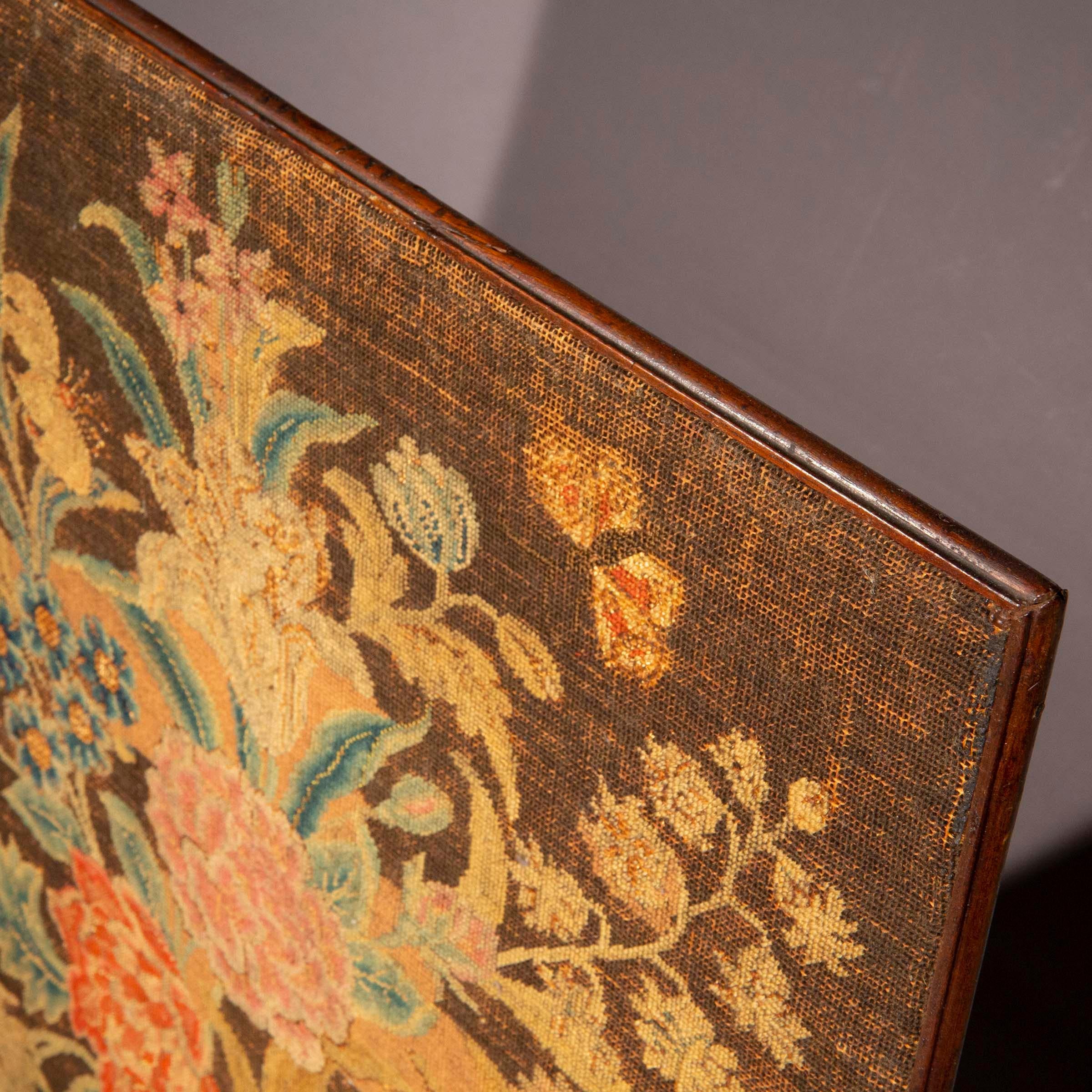 A charming petit-point needlework picture of floral design, in its original convex moulding frame.

English, late 18th century.