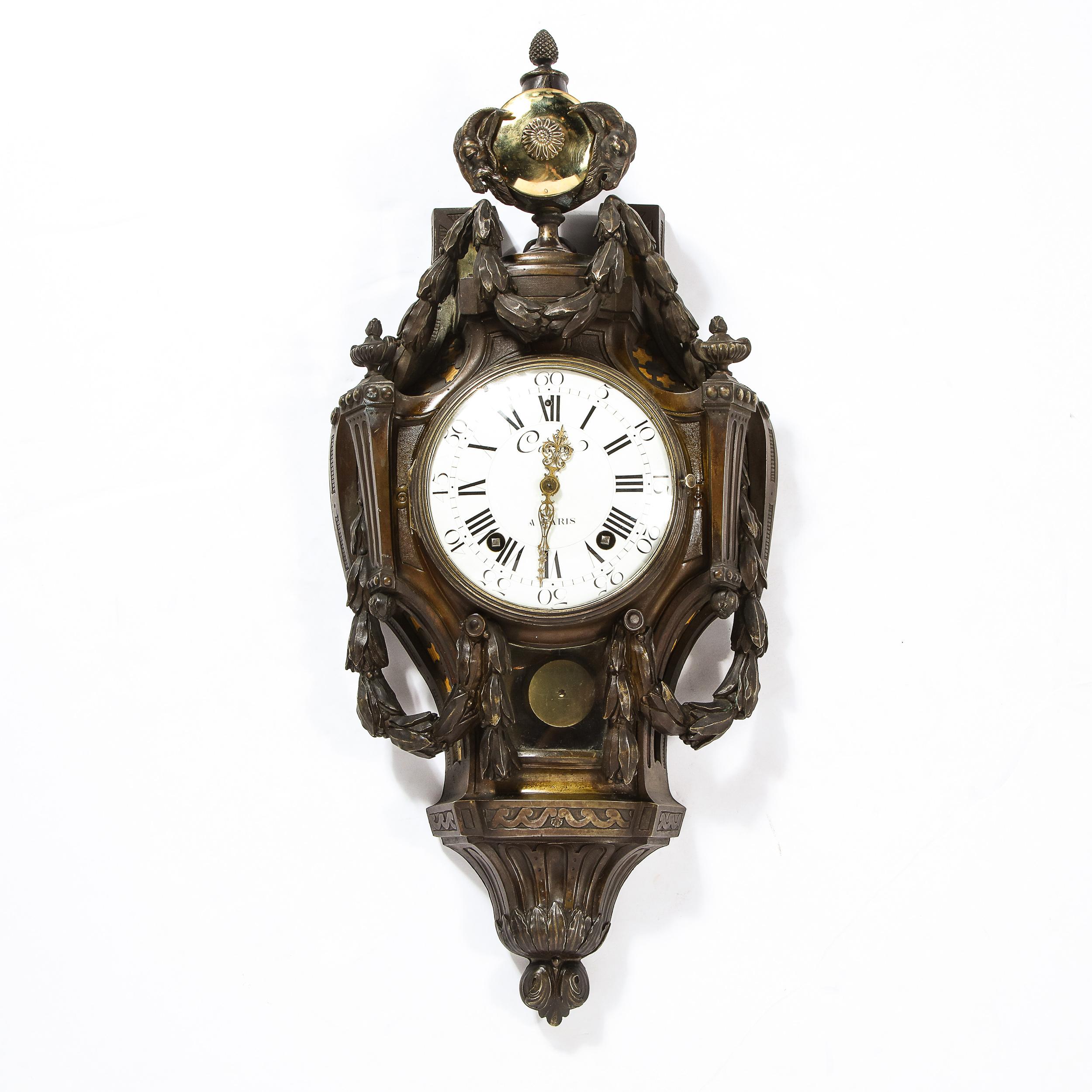 This elegant wall clock was realized in Paris, France during the 18th century by the celebrated maker Caron. It offers an ovoid body with a circular polished brass chime with a starburst motif in the center at the top flanked on either side by