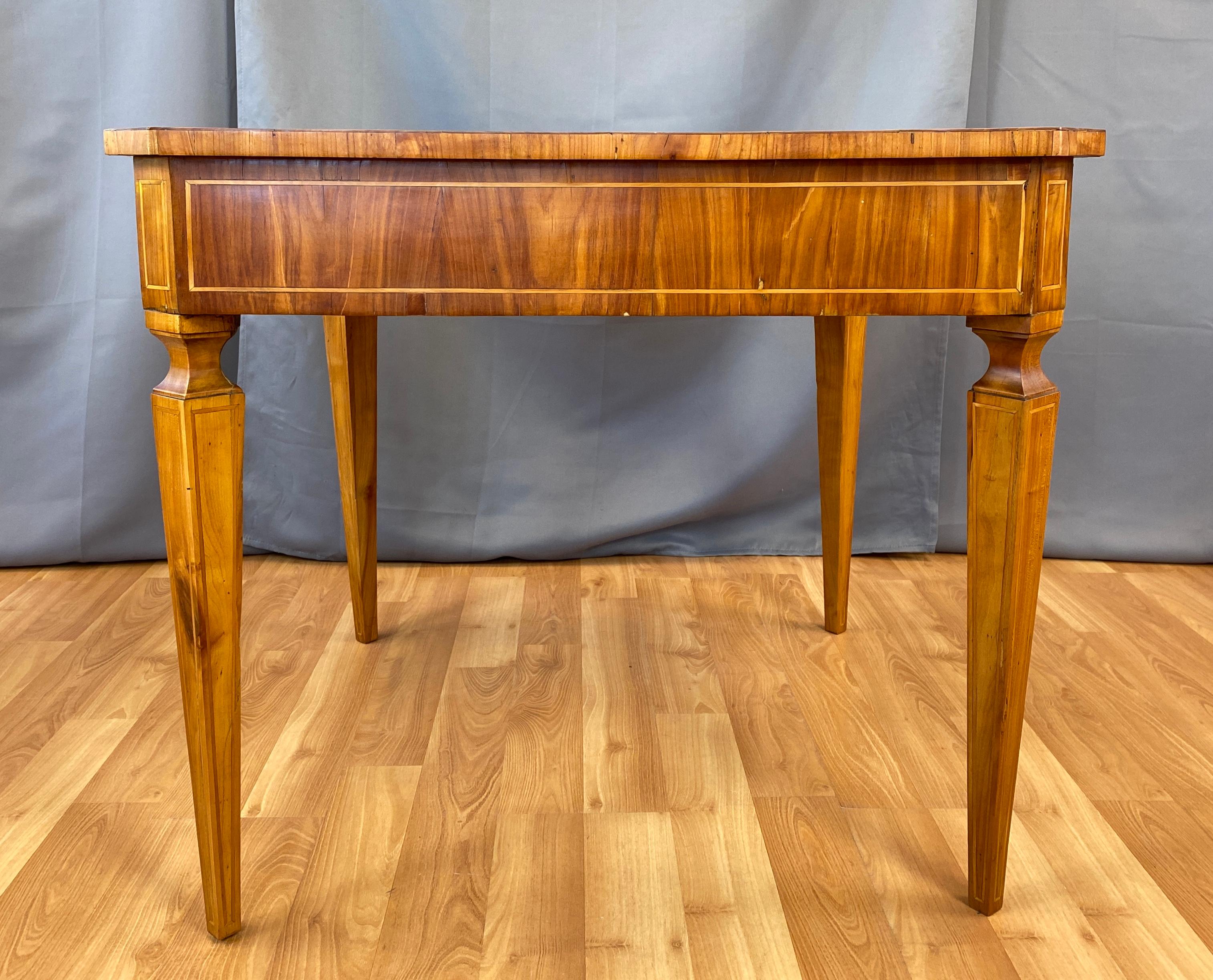 A 18th century Italian marquetry Cherry table with a single drawer.
Exquisitely handcrafted writing or gaming table, inlaid from it's top down it's legs that are slender and tapered. 
Table has wonderful proportions, and a beautifully warm patina