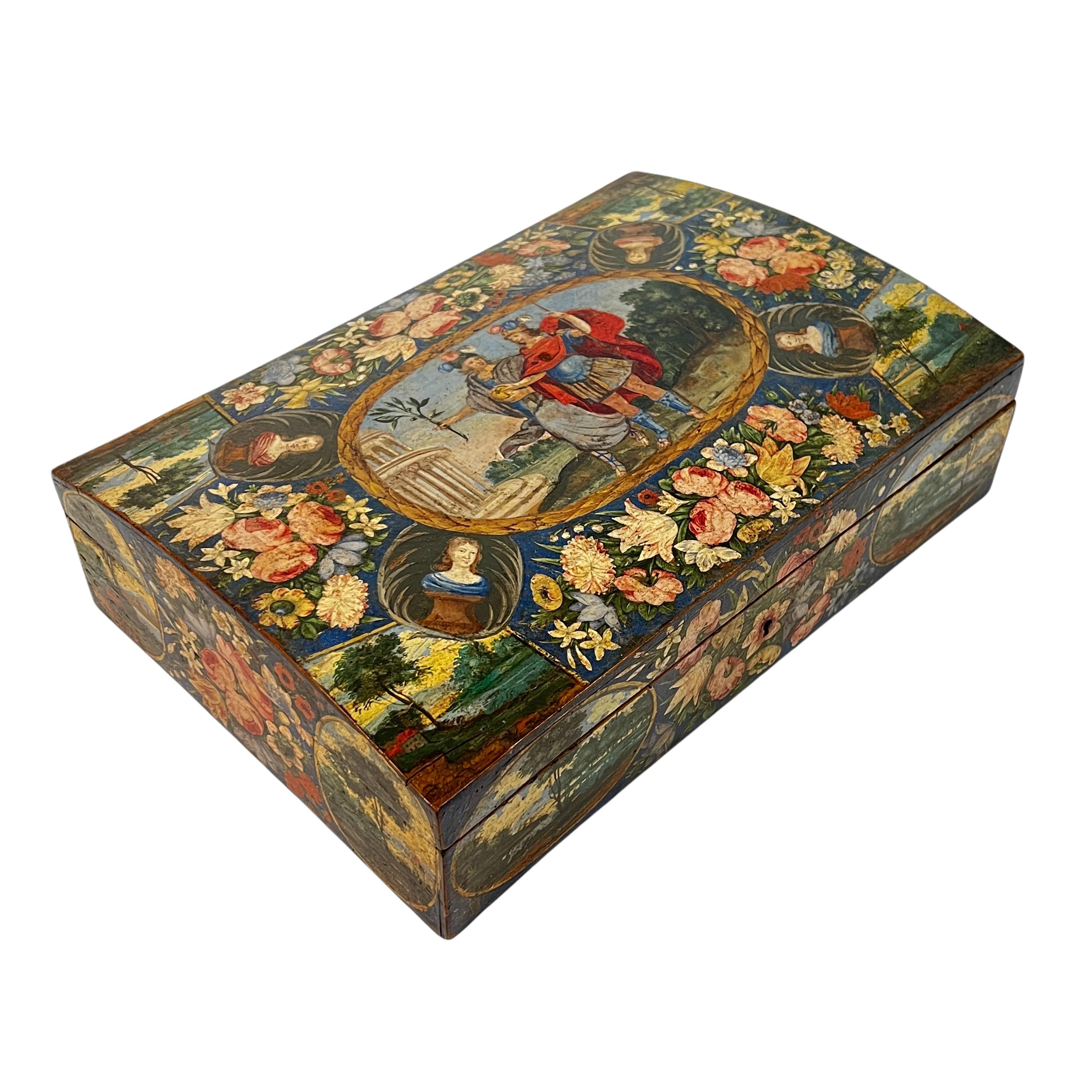 Our writing box measuring 14 by 9 1/2 by 4 inches dates from the late seventeenth century and is likely of Dutch or French origin. It features hand-painted flowers and landscapes on each side, and figures on the domed lid walking side-by-side in an