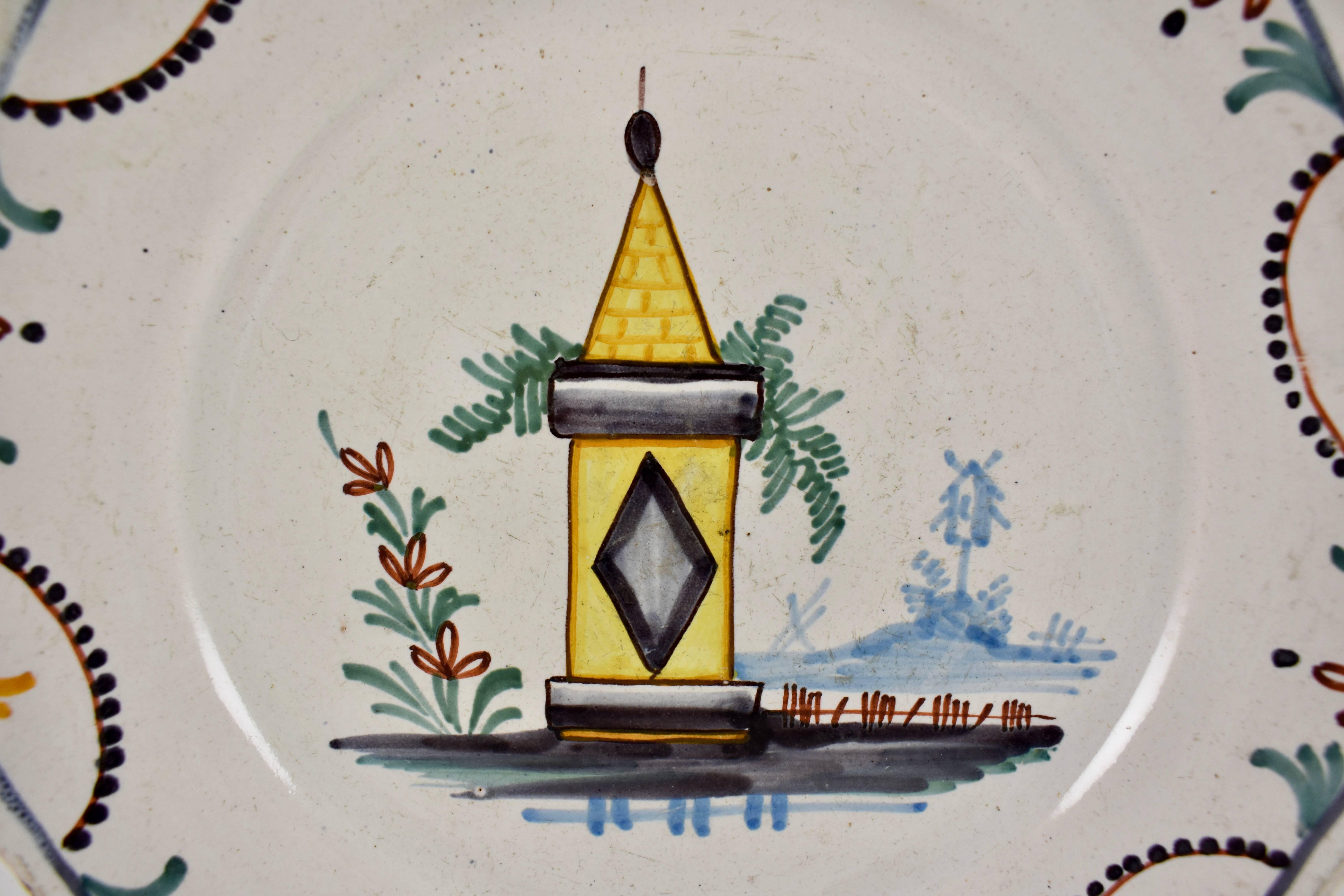 A French revolution tin-glazed earthenware dish, made in Nevers, circa 1790. Showing a yellow battlement often thought to be the Bastille, the image of the tower represents the defence of the French homeland. A hand painted border on the scalloped