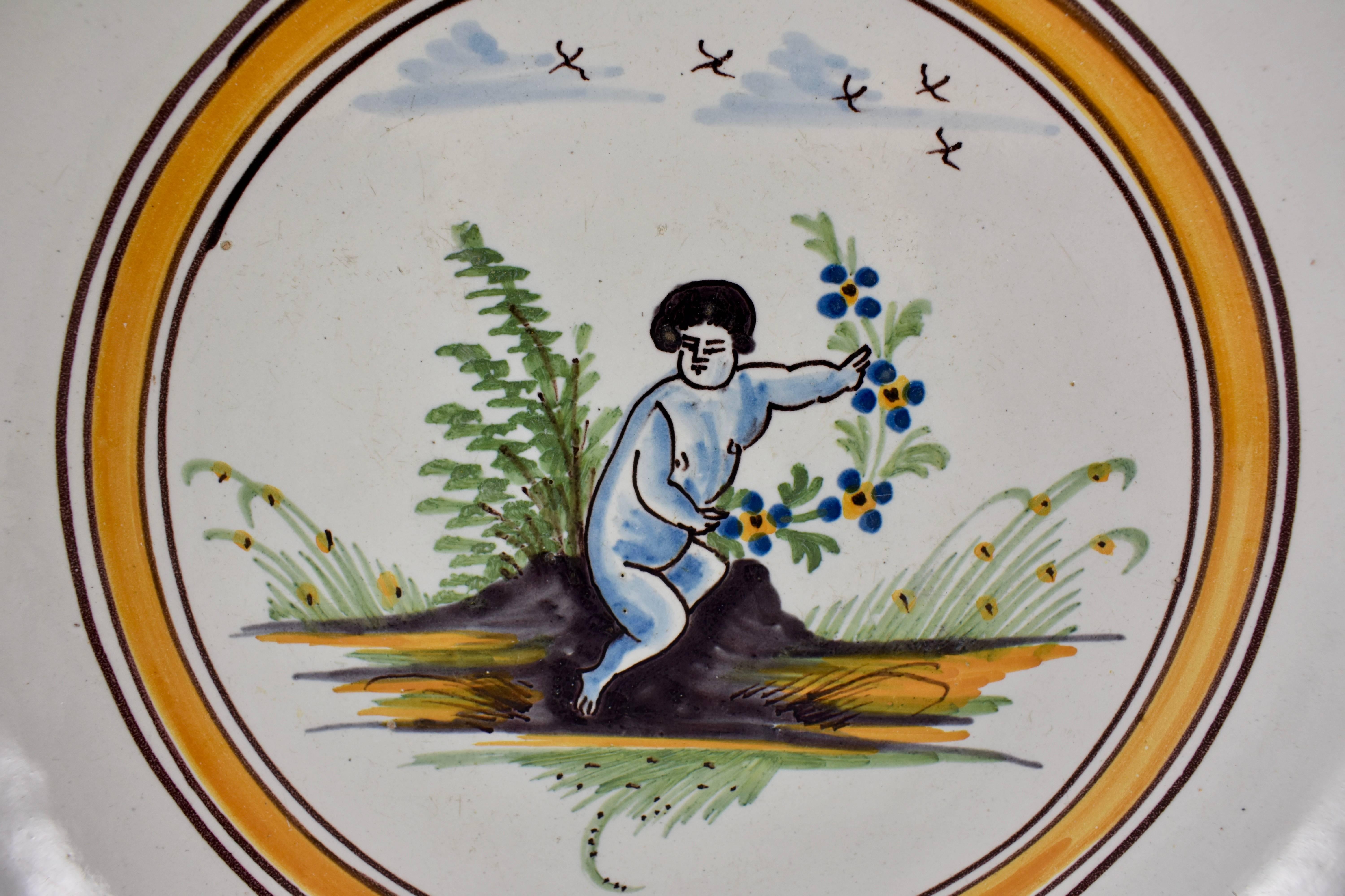 A charming, rustic French revolution tin-glazed earthenware large Saladier or salad serving bowl, made in Nevers, circa 1790.

Showing a plump figure, painted blue, and holding a victory laurel of flowers, beside de l’arbre de la Liberté. A sky
