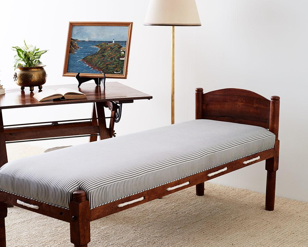 Charming late 18th century New England cherry daybed or rope bed made in the Federal style and period. Features a newly upholstered frame with a blue and white ticking stripe and rope with a nautical theme. Excellent joinery with wood peg