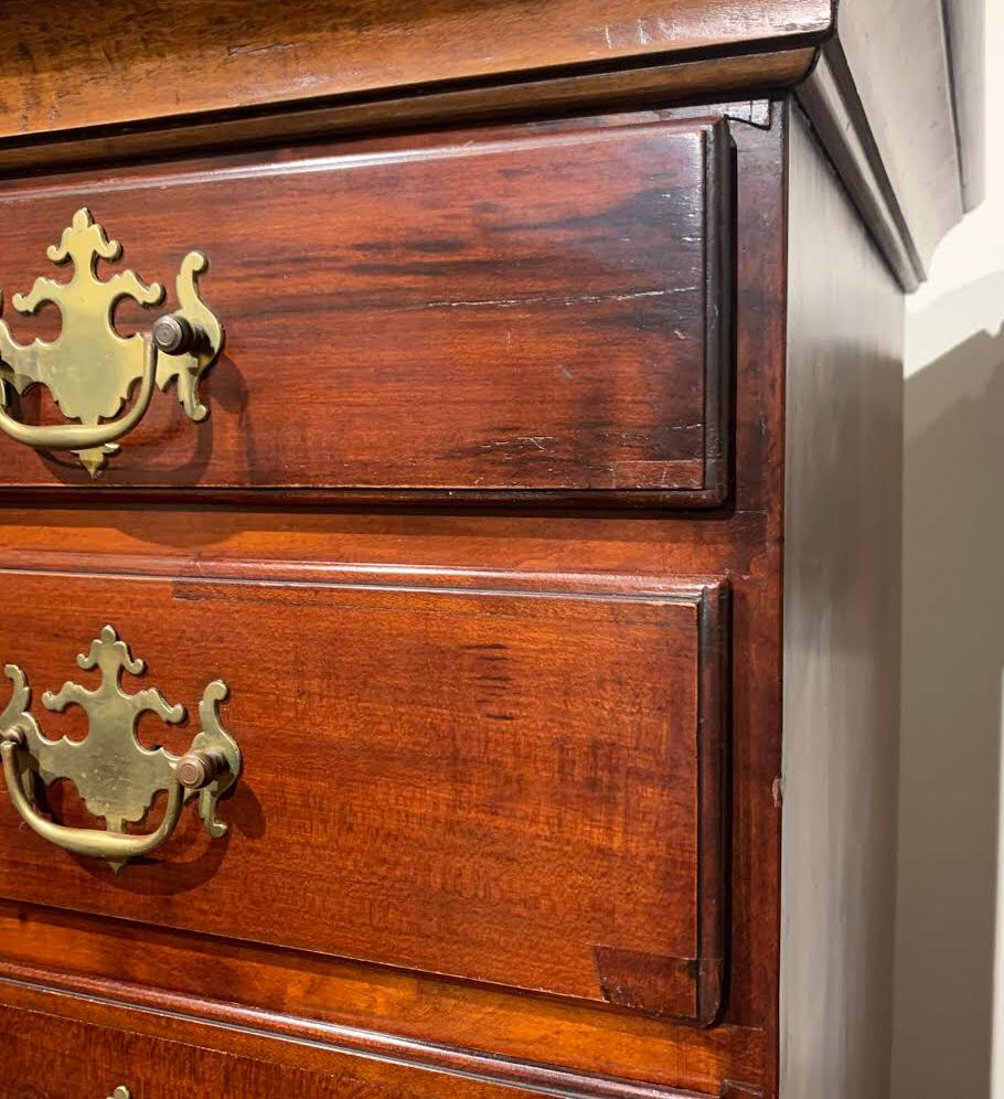 A fine two part New England maple highboy, probably Rhode Island in origin, its upper case with a molded cornice surmounting a five graduated long drawers (faux two drawer front on the top drawer) and its lower case with two long drawers, the lower