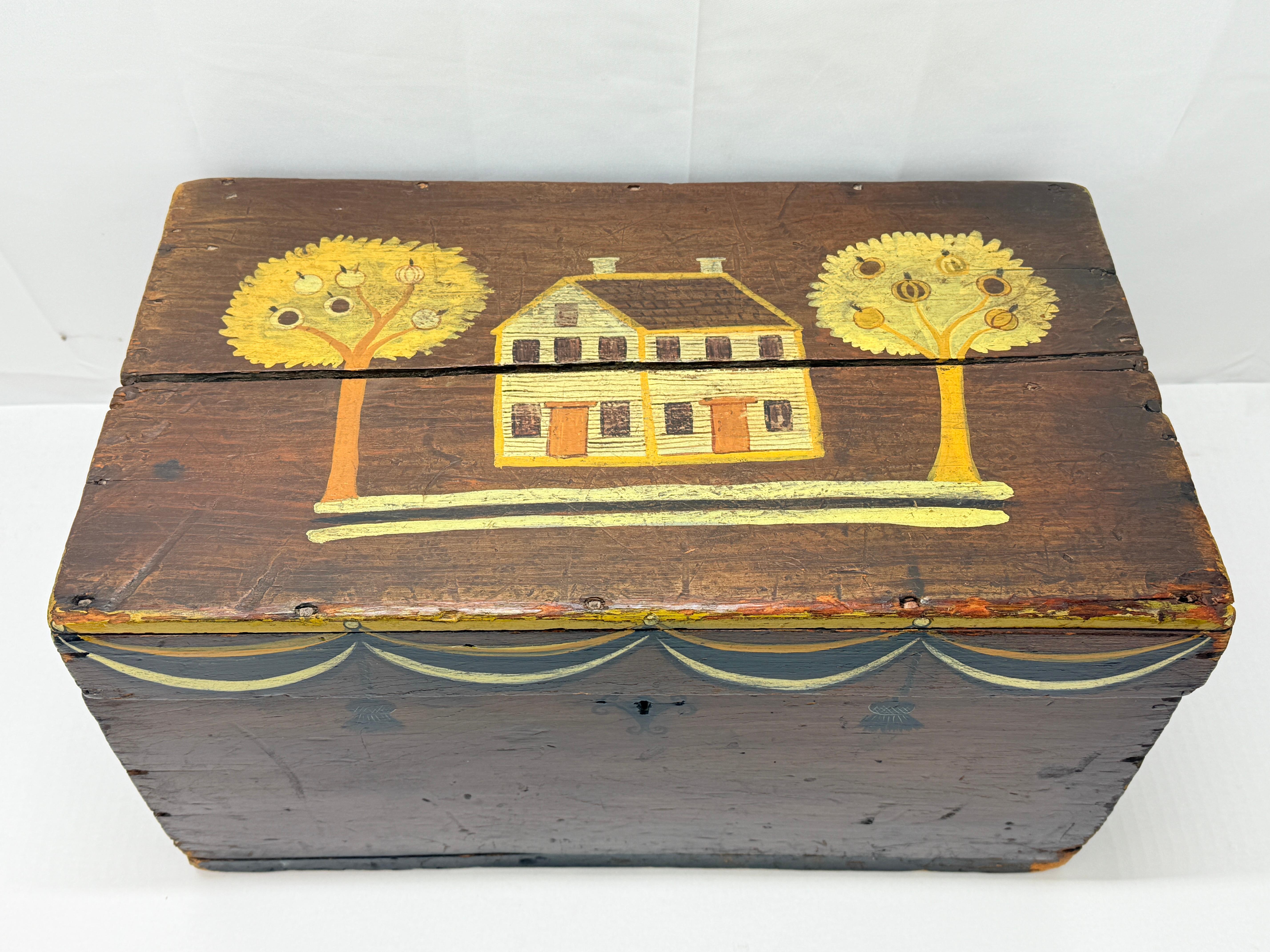 This charming hand-painted wooden box exemplifies early American folk art, blending utility with artistry. The box is constructed with rose head nails, a detail indicative of late 18th-century craftsmanship. The hinged lid features a naïve yet