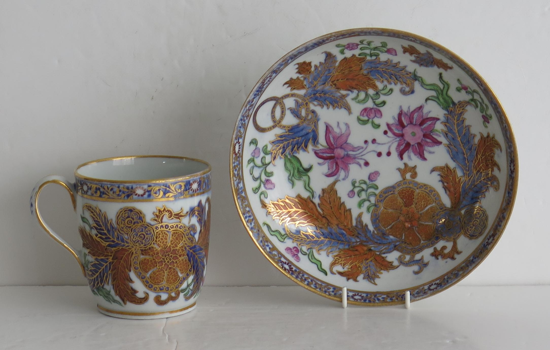 This is a finely decorated porcelain coffee cup and saucer, by New Hall in pattern 274, dating to the late 18th century George 111rd period, circa 1795.

Both pieces are well potted, the cup on a low foot with a plain loop handle.

They are