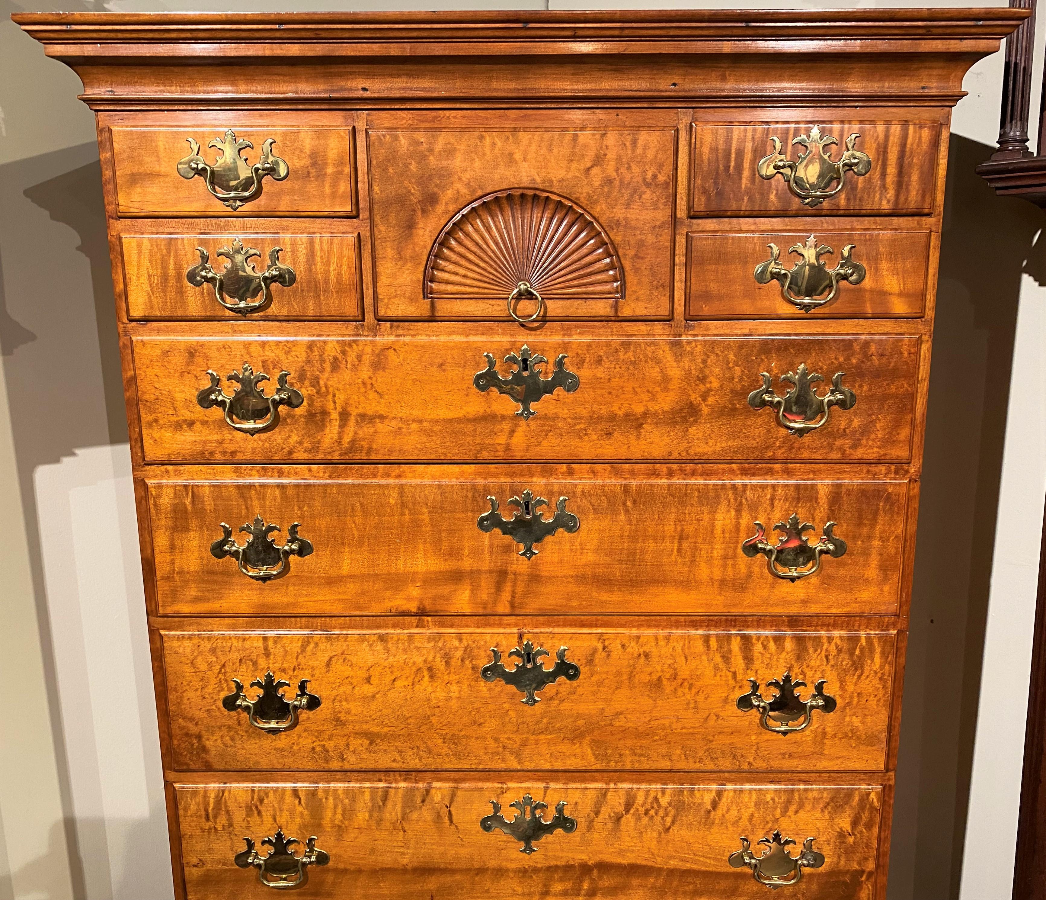 A splendid New Hampshire Dunlap School Chippendale chest on chest, its upper case featuring a molded cornice surmounting a central drawer with radial fan carving flanked by four small fitted drawers, over four graduated long drawers, over a lower