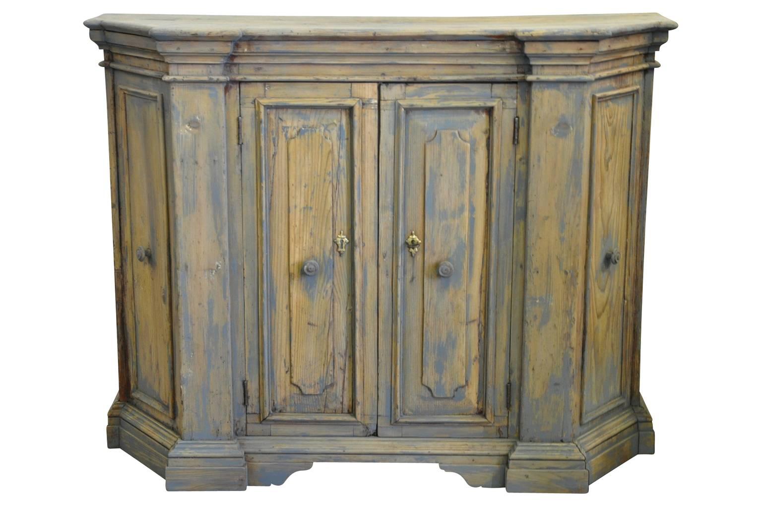 A charming later 18th century credenza from Northern Italy. Wonderfully constructed from pine with a very handsome molded crown over paneled doors.