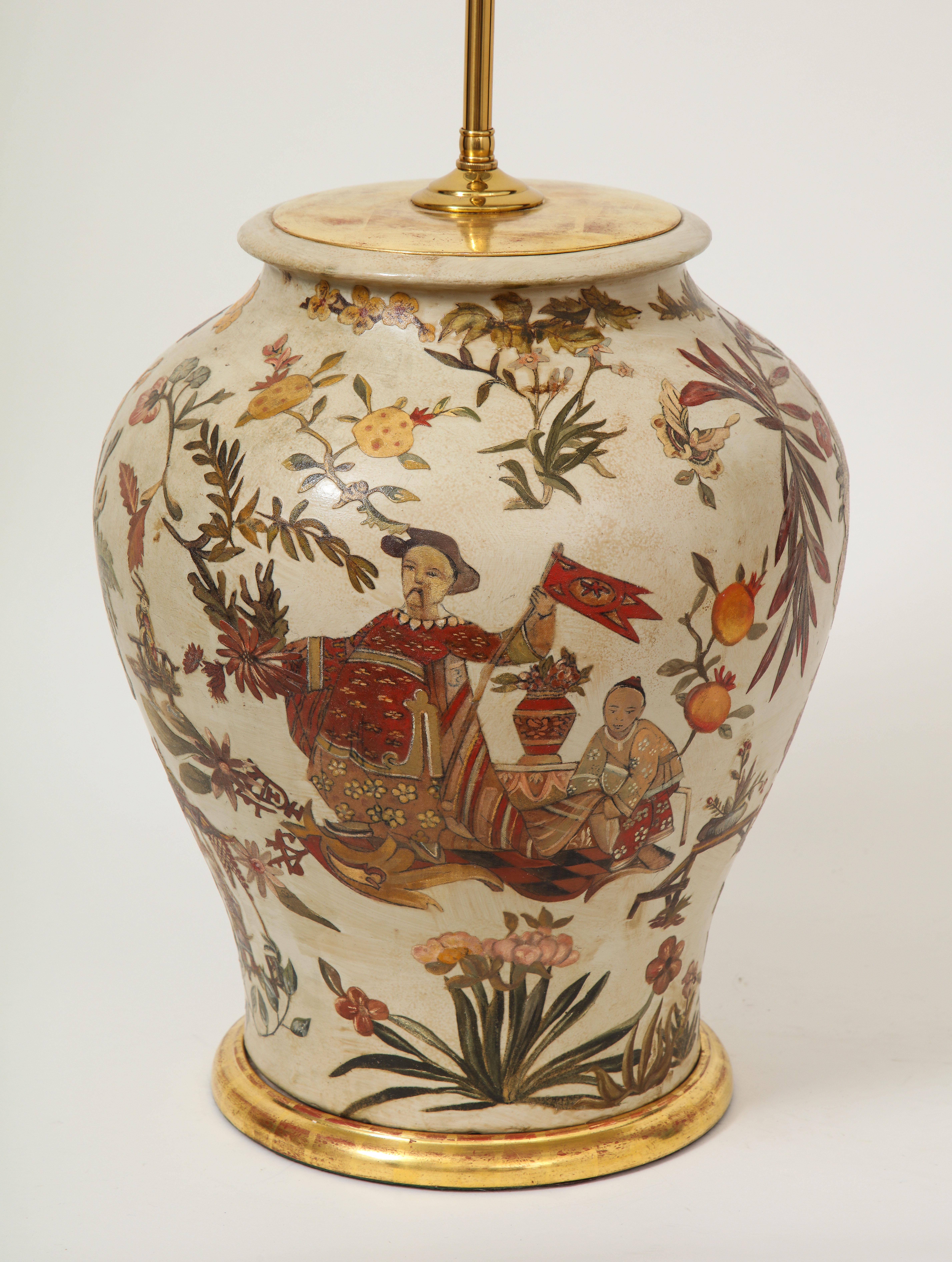 The baluster form terra cotta vase decorated with Chinoiserie decoration including a Court figure waving a banner with an attendant, persimmons, orchids, peonies and other emblems of good fortune on cream ground. 