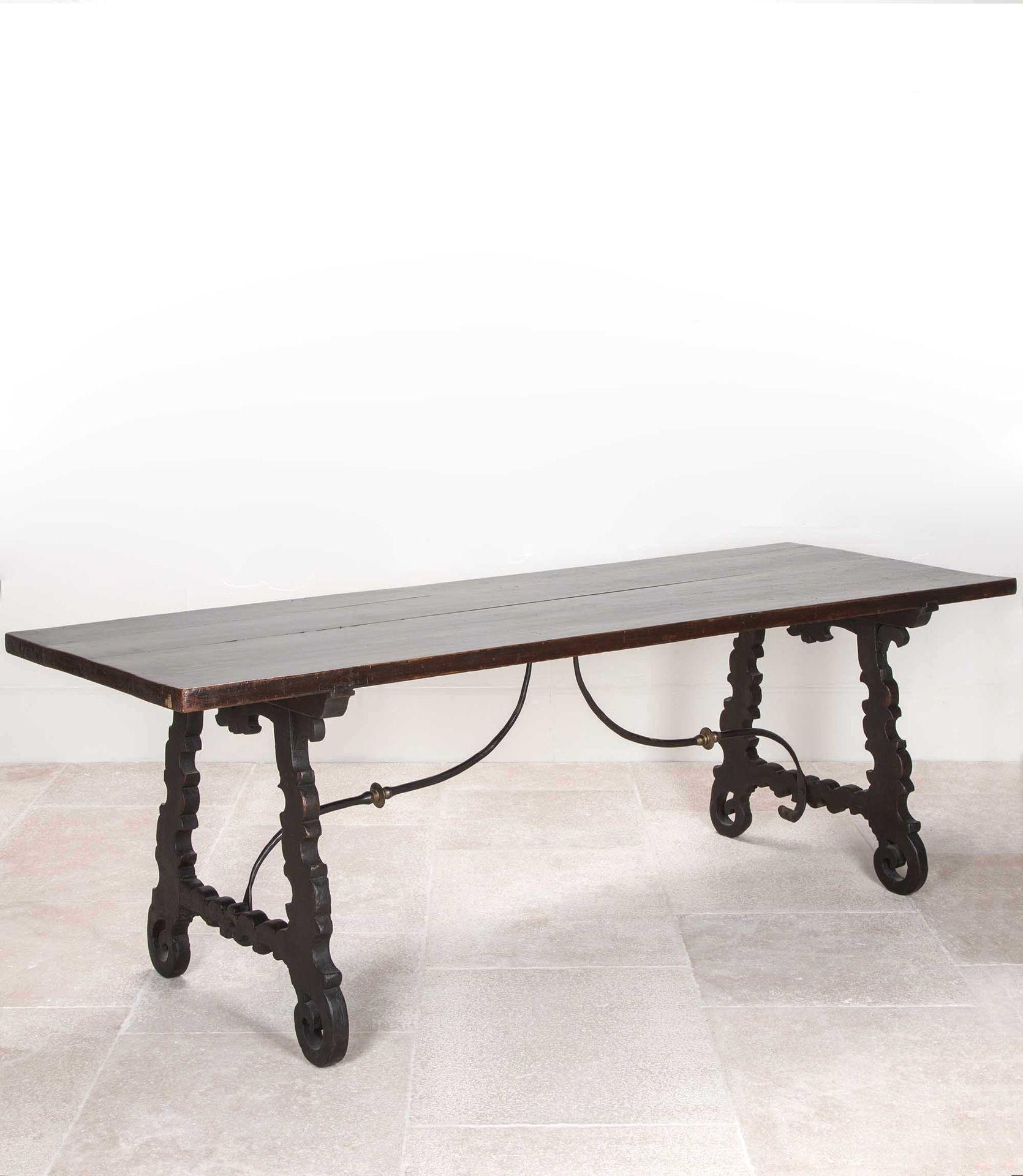18th Century Northern Italian walnut table. With iron cross bar and elegantly carved lyre shaped legs.